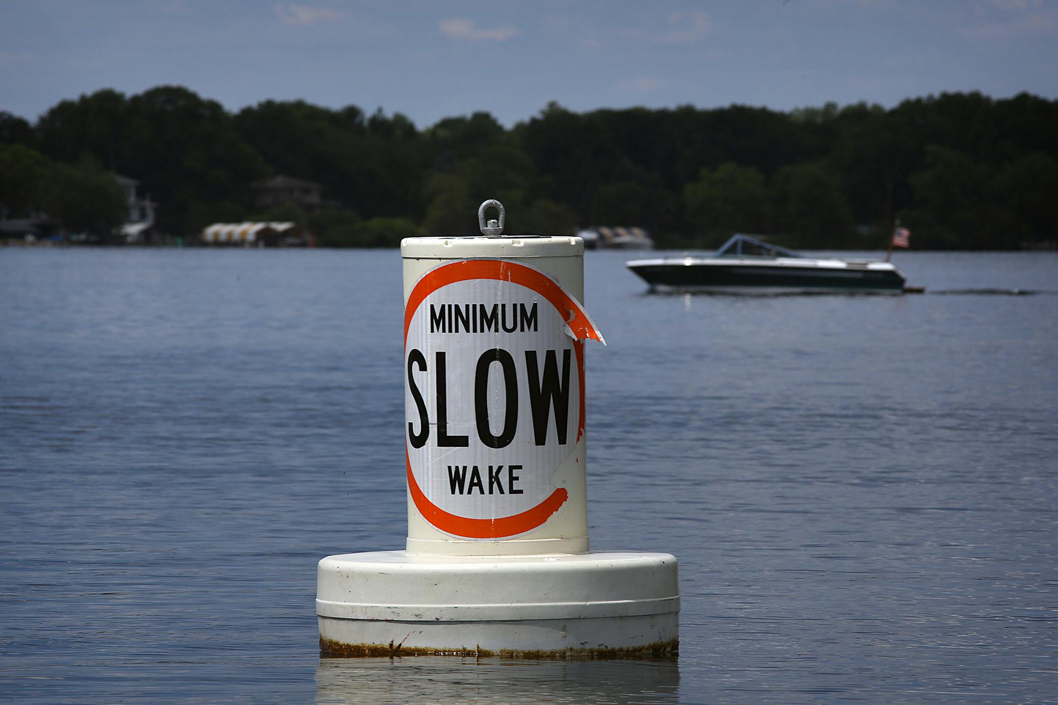 A buoy informed boaters of the rules in force on Lake Minnetonka in July designed to reduce wakes.