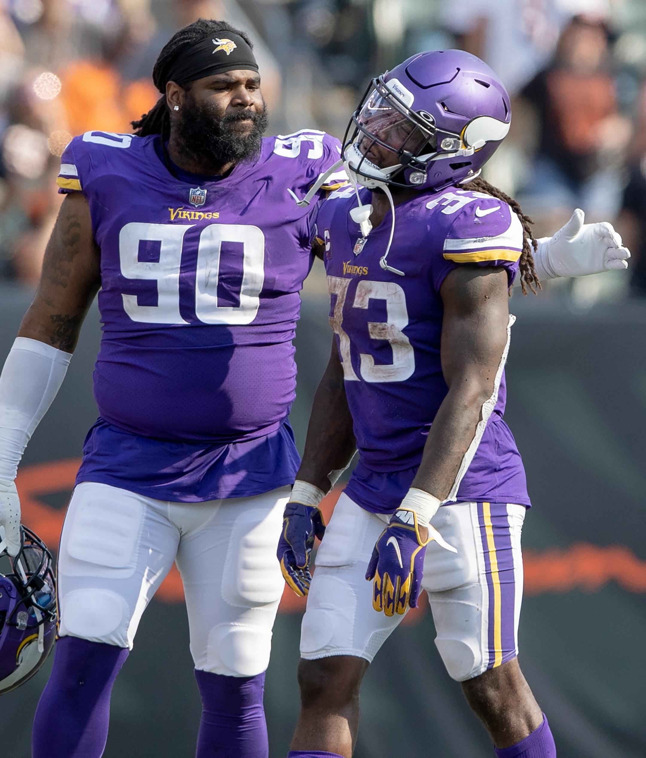 Minnesota Vikings defensive tackle Sheldon Richardson (90) patted Dalvin Cook (33) on the back after he fumbled the ball in overtime.