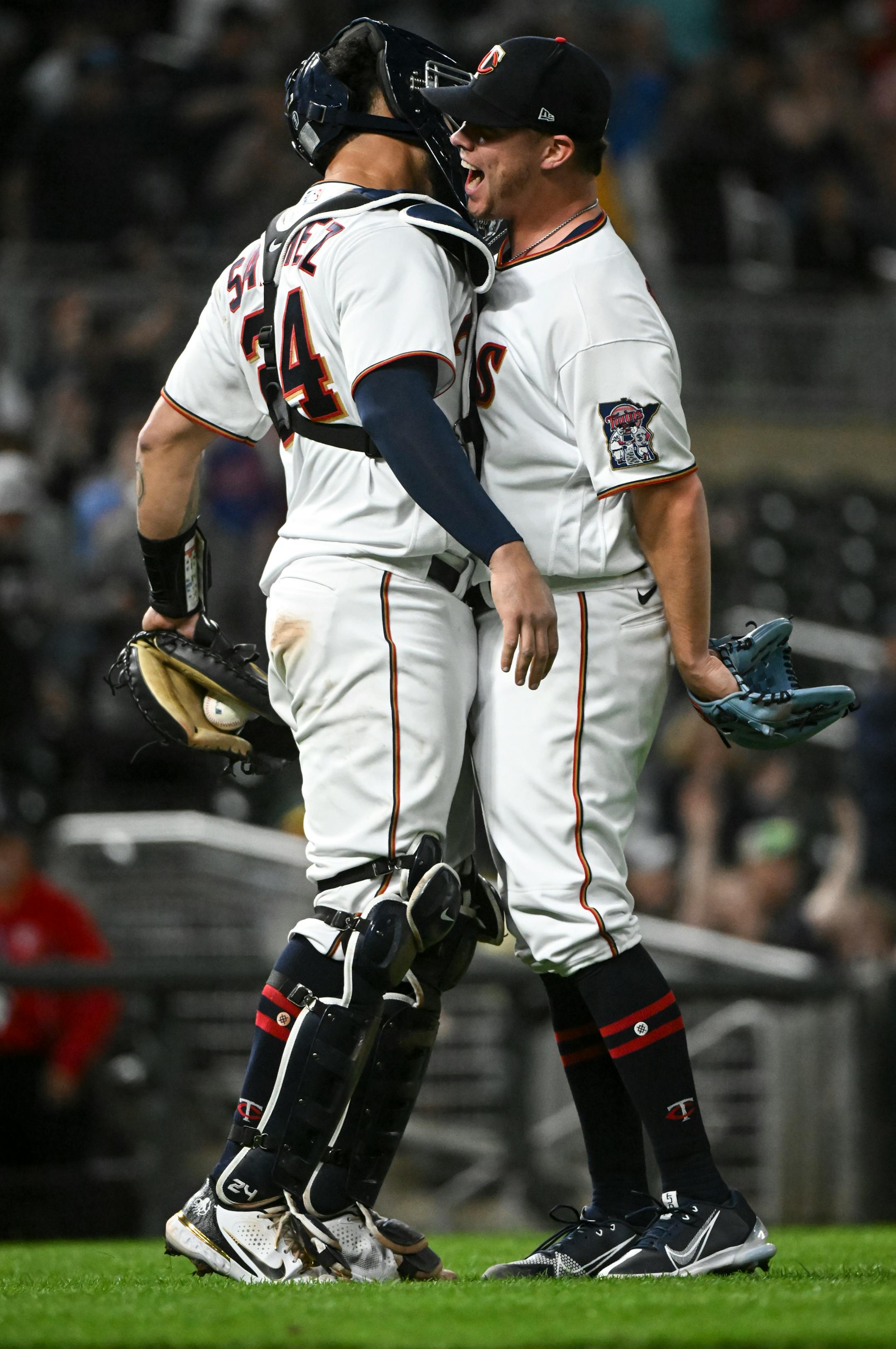 Minnesota Twins relief pitcher Emilio Pagan (12) celebrates with catcher Gary Sanchez (24) after striking out Oakland Athletics left fielder Chad Pinder (10) to end the game.