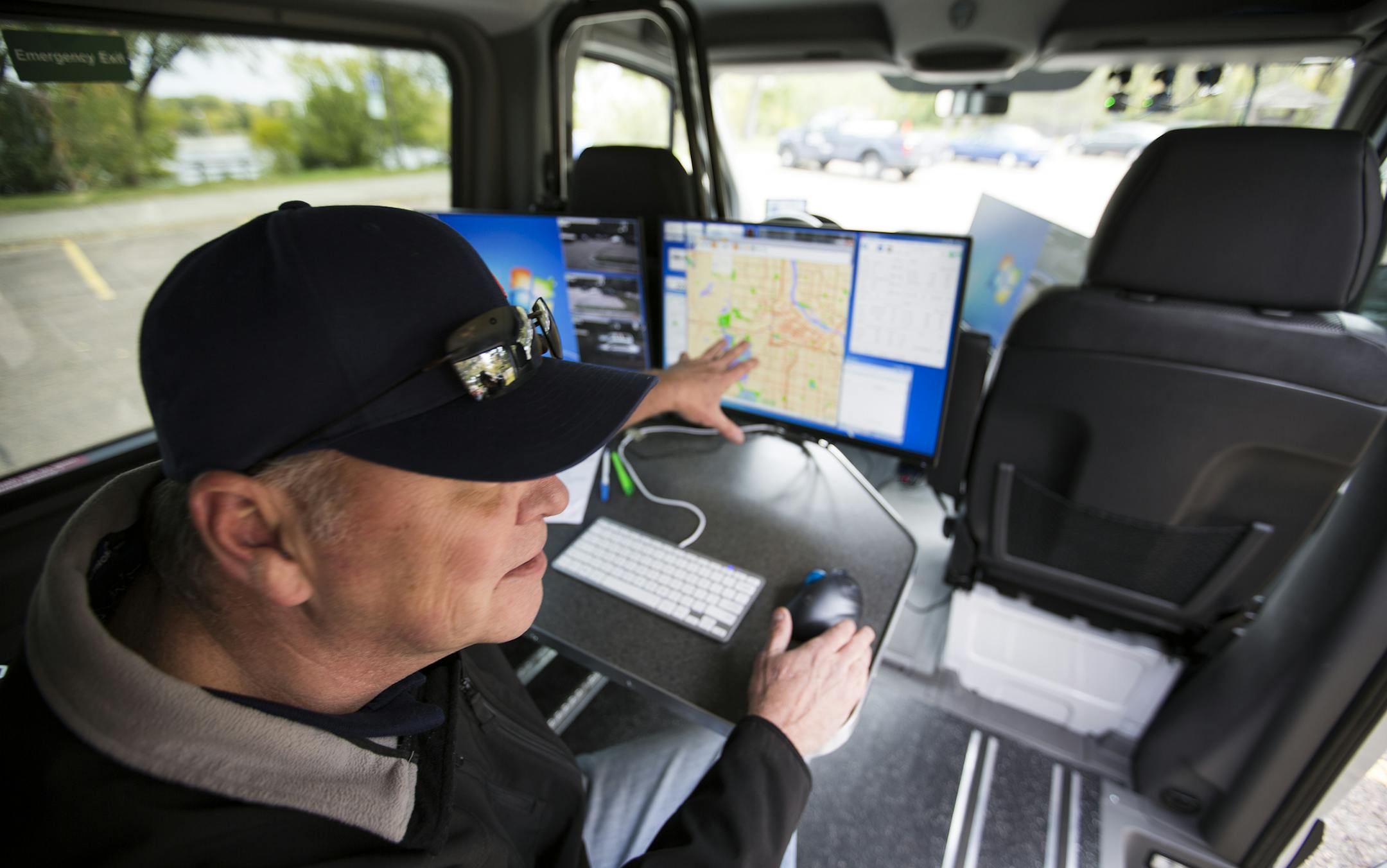 Toby Homuth looks at a map on the computer inside the Dynatest van.