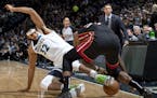 Karl-Anthony Towns (32) of the Minnesota Timberwolves and Chris Silva (30) of the Miami Heat fought for the ball in the first quarter.