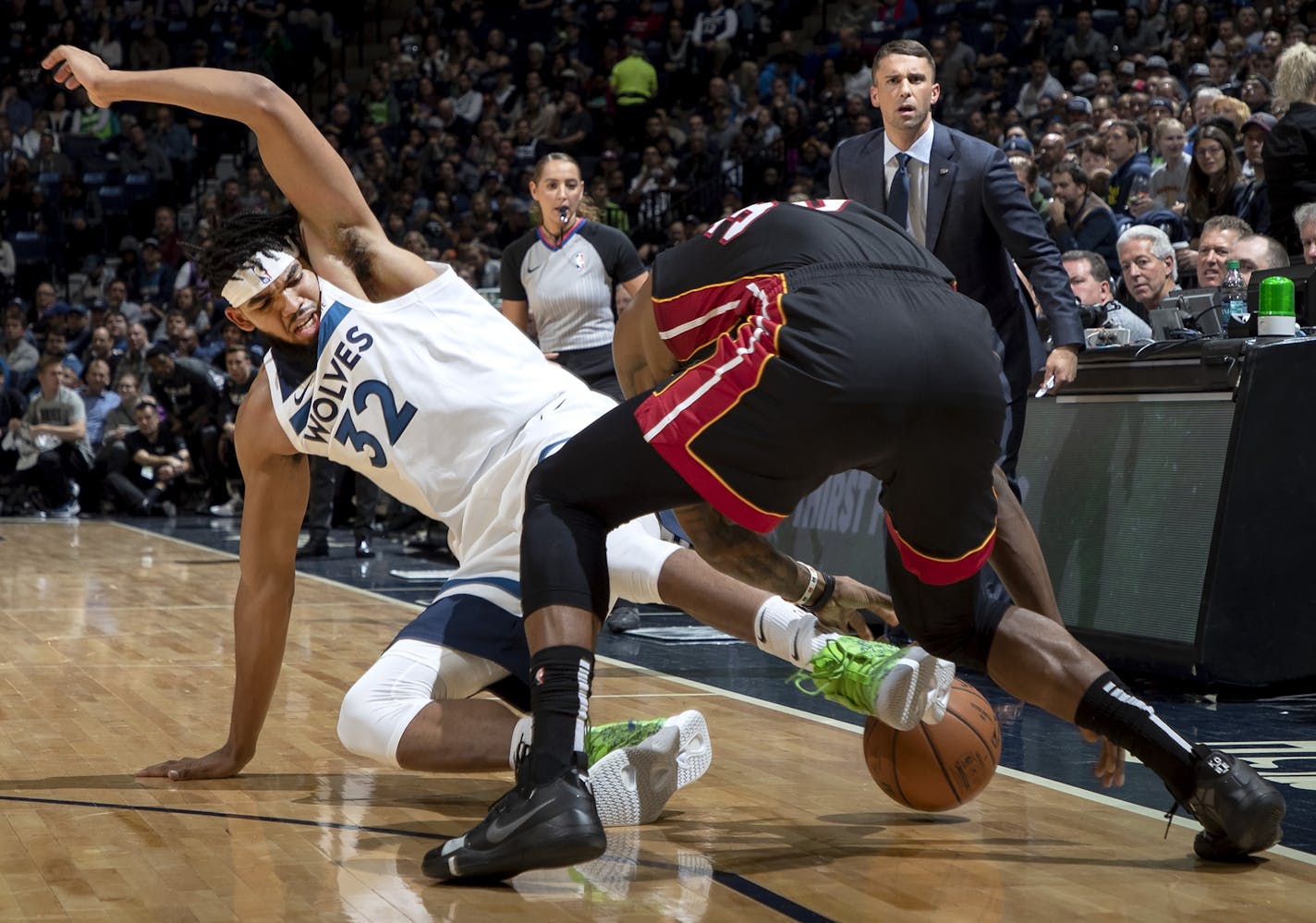 Karl-Anthony Towns (32) of the Minnesota Timberwolves and Chris Silva (30) of the Miami Heat fought for the ball in the first quarter.