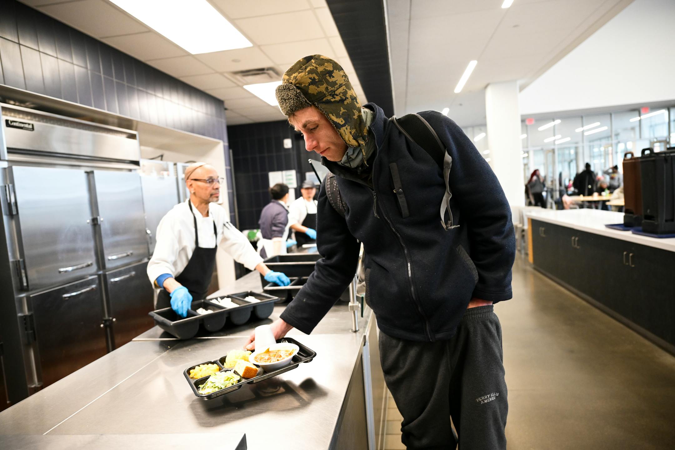 Michael Lowe, of St. Paul, takes his lunch trey while sheltering from the cold Friday at the Dorothy Day Opportunity Center "It's tough," said Lowe of living on the streets in winter.