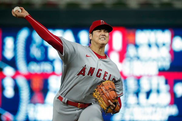 Shohei Ohtani throws to a Twins batter during the third inning Friday