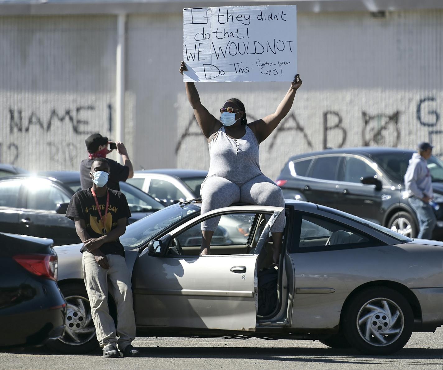 Alexandria White held a sign as she sat atop a car in the Nicollet Kmart parking lot alongside her boyfriend, Terion Willaims. "Peaceful protest hasn't worked in the past.", said White. "Folks are tired." aaron.lavinsky@startribune.com Protests continued in the wake of George Floyd's death in police custody on Saturday, May 30, 2020 in Minneapolis, Minn.