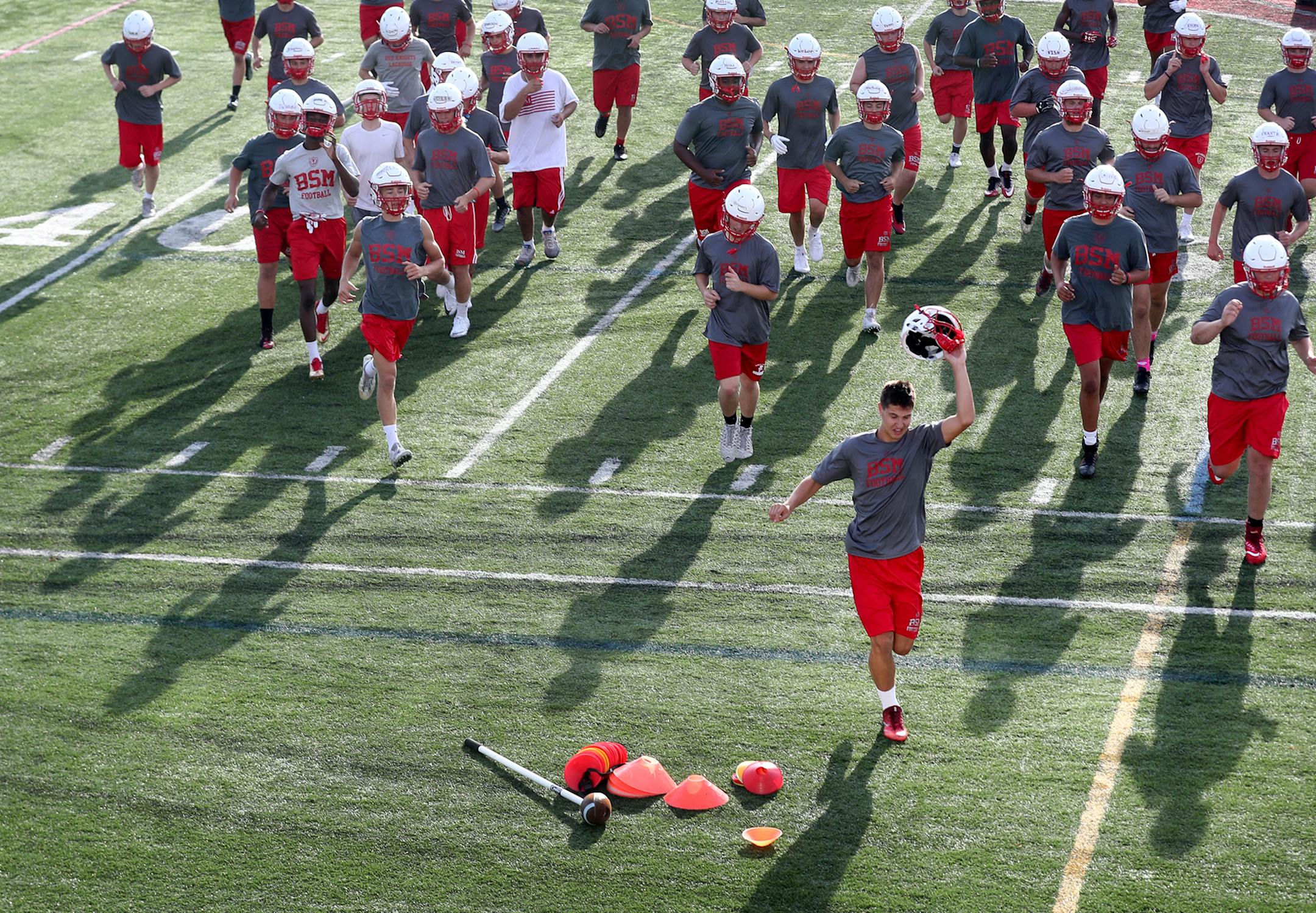 After participating in drills, Benilde-St. Margaret's players headed for water during a break in the second day of practice.