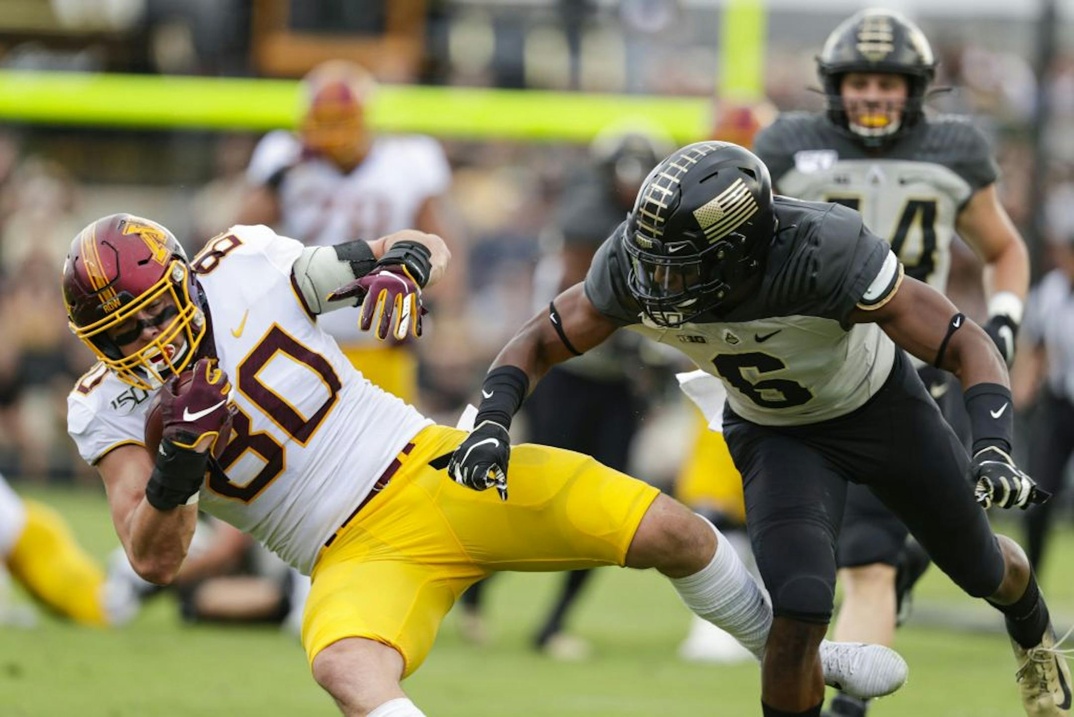 Purdue safety Jalen Graham (6) tackles Minnesota tight end Jake Paulson (80) during the first half of an NCAA college football game in West Lafayette, Ind., Saturday, Sept. 28, 2019.