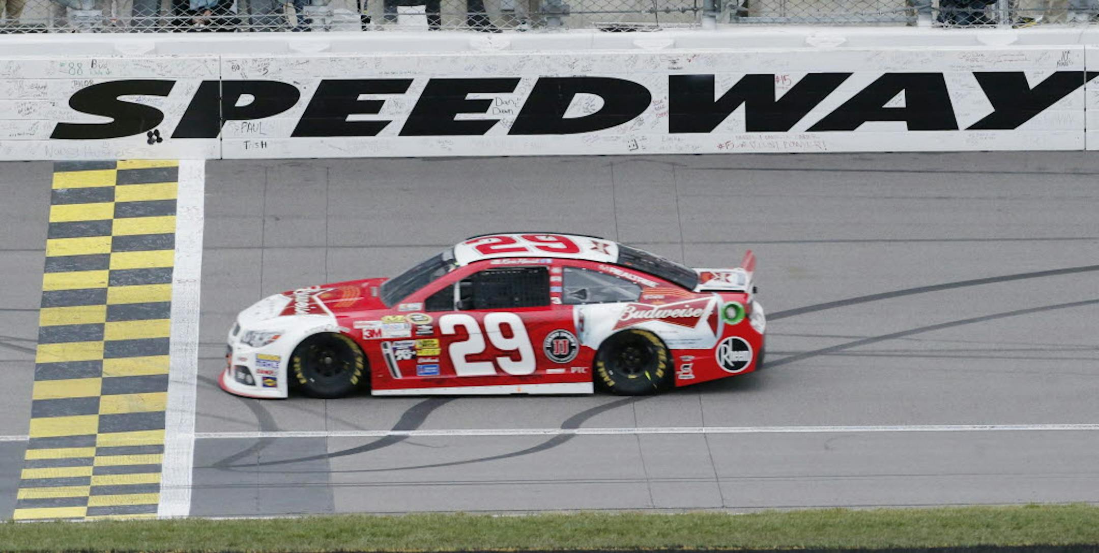 Kevin Harvick (29) crosses the finish line to win Sunday's NASCAR Sprint Cup series race at Kansas Speedway.