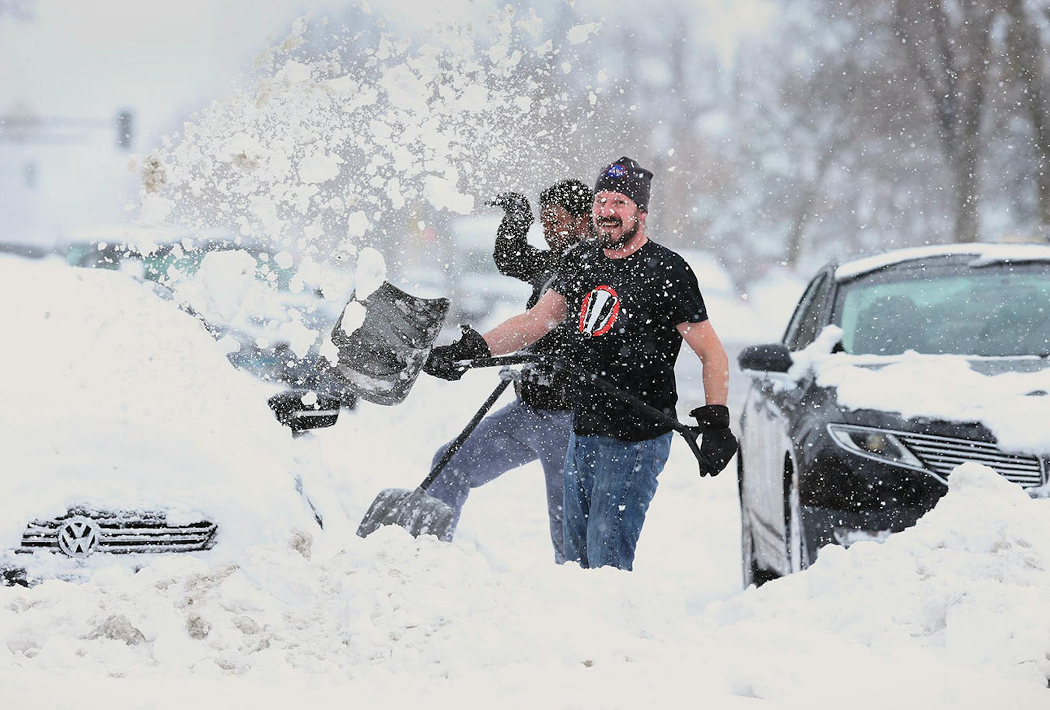 Neighbors John Bauer left and Fahmi Osman helped resident in the 3200 block of Portland Avenue dig there cars out of the snow after Saturdays blizzard Sunday April 15, 2018 in Minneapolis, MN.