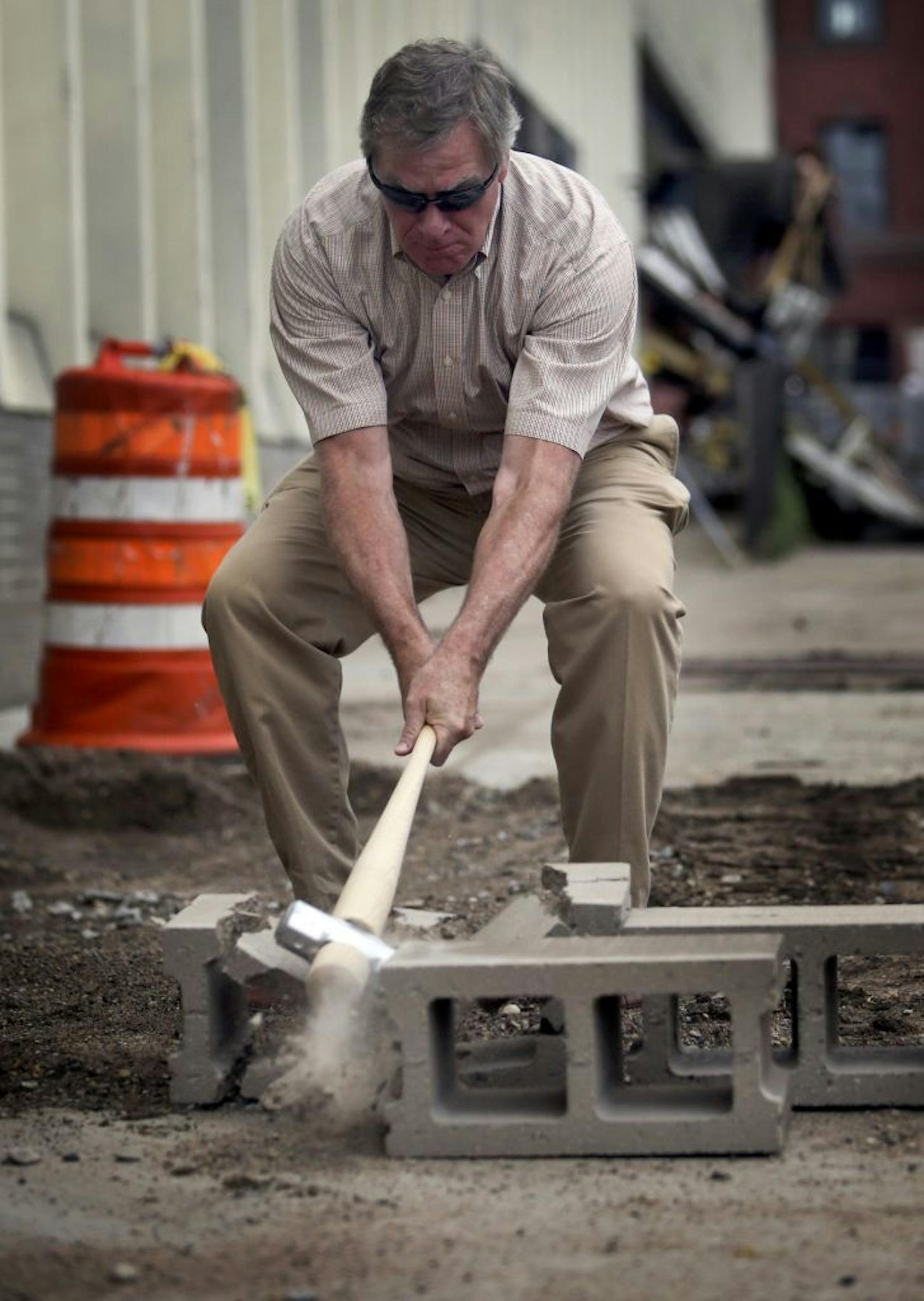 St. Paul mayor Chris Coleman used a baseball bat/sledgehammer on a piece of concrete block during the ceremony Saturday, July 13, 2013, in St. Paul, MN.