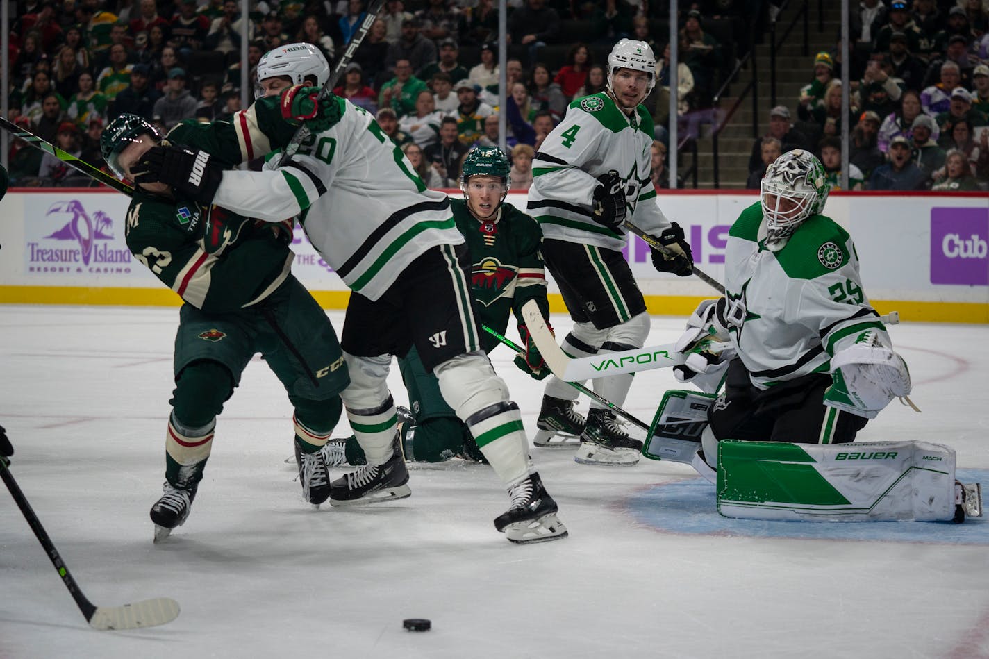 Minnesota Wild left wing Matt Boldy (12) looks at the puck after a missed goal as two other players fight at the game against the Dallas Stars at Xcel Energy Center in St. Paul, Minn. on Sunday, Nov. 12, 2023. ] Angelina Katsanis • angelina.katsanis@startribune.com