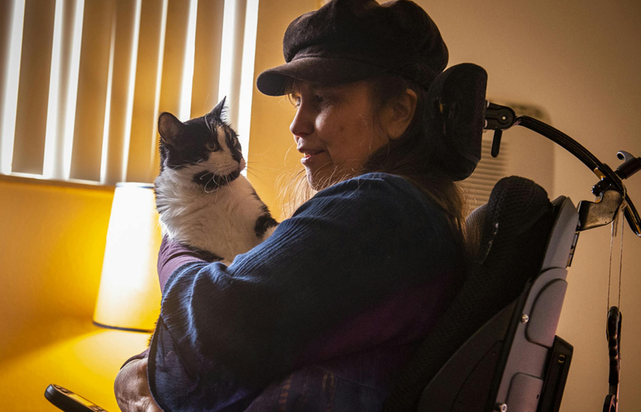 Denise Hok holds her 4-year-old cat, Moo, at home in Colorado Springs, Colo., on October 12, 2018. (Dougal Brownlie/Kaiser Health News/TNS)
