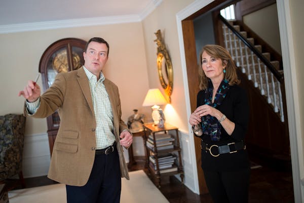Real estate agent Chad Larsen talked with Kate Helms about her living room windows during a walk through Tuesday afternoon. ] (AARON LAVINSKY/STAR TRI