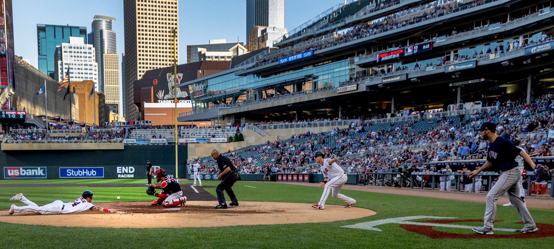 Jose Miranda of the Minnesota Twins beats the tag by Boston Red Sox catcher Reese Mcguire to score in the first inning.