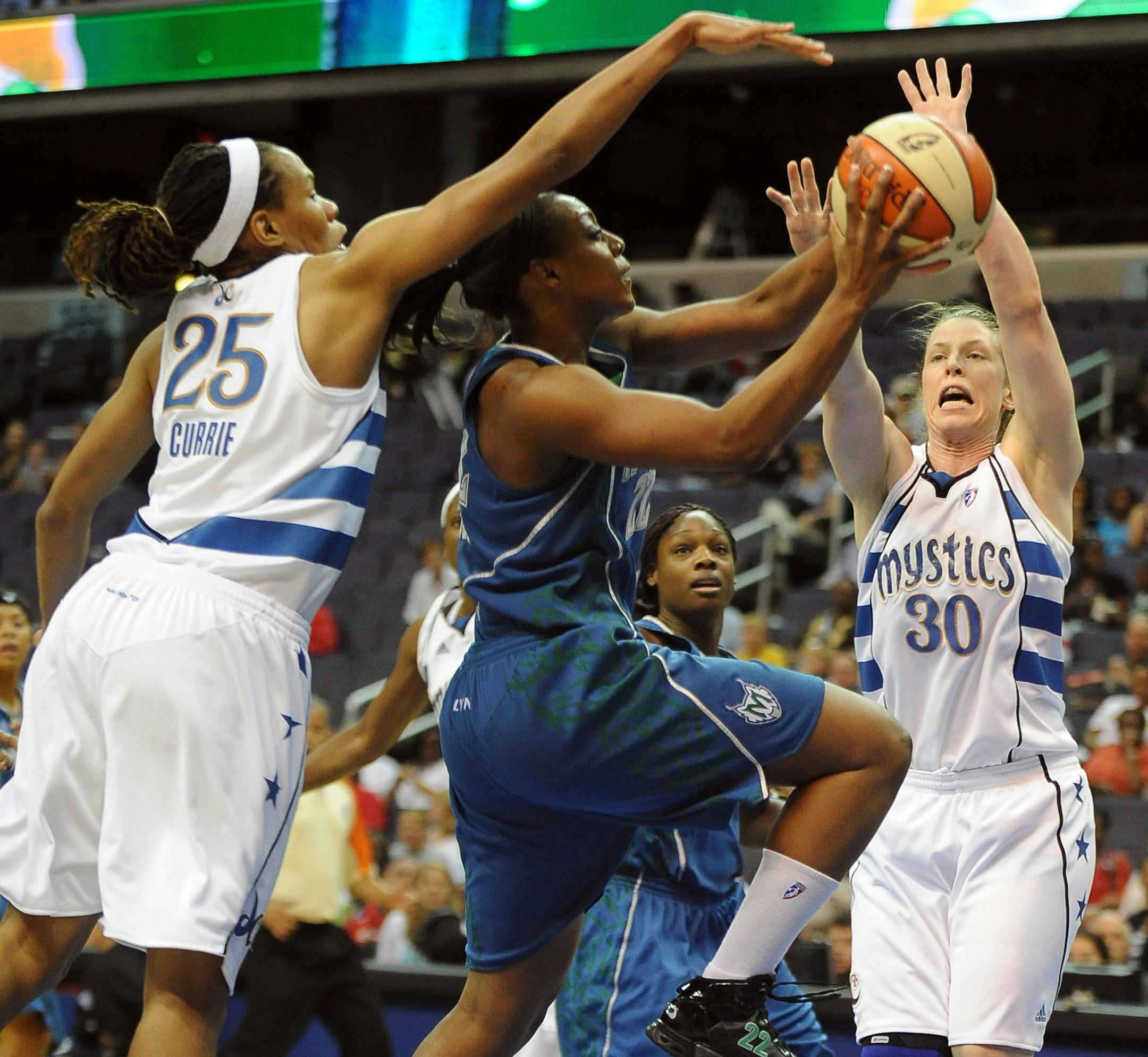 The Minnesota Lynx's Monica Wright, center, drives to the basket between Washington Mystics defenders Monique Currie (25) and Katie Smith (30) during the first quarter. The Mystics defeated the Lynx, 61-58, at the Verizon Center in Washington, D.C., Friday, August 13, 2010. (Chuck Myers/MCT)