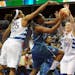 The Minnesota Lynx's Monica Wright, center, drives to the basket between Washington Mystics defenders Monique Currie (25) and Katie Smith (30) during 