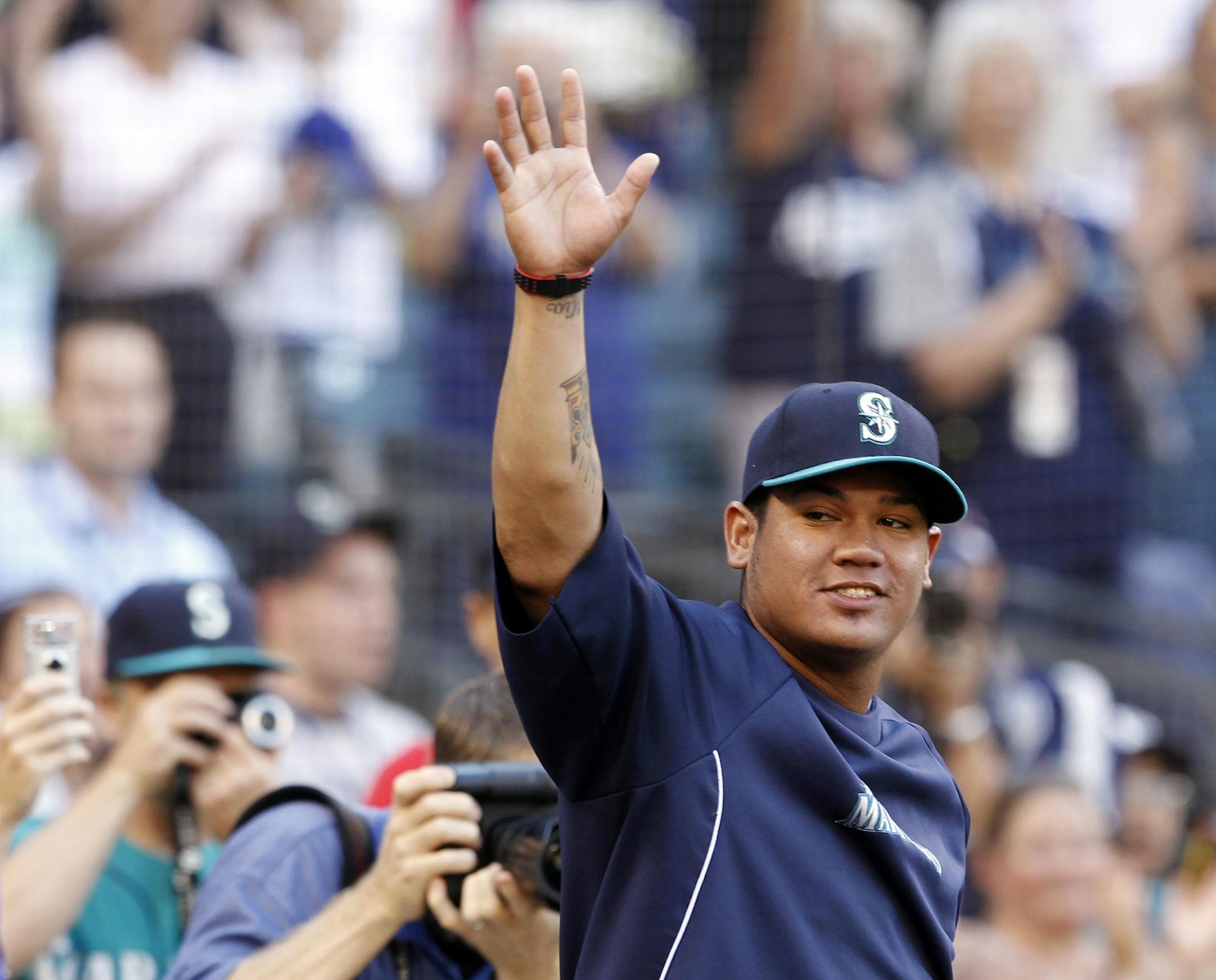 Seattle Mariners pitcher Felix Hernandez acknowledges fans as he is recognized before a baseball game against the Minnesota Twins Friday, Aug. 17, 2012, in Seattle. Hernandez pitched the first perfect game in Mariners history two days earlier.