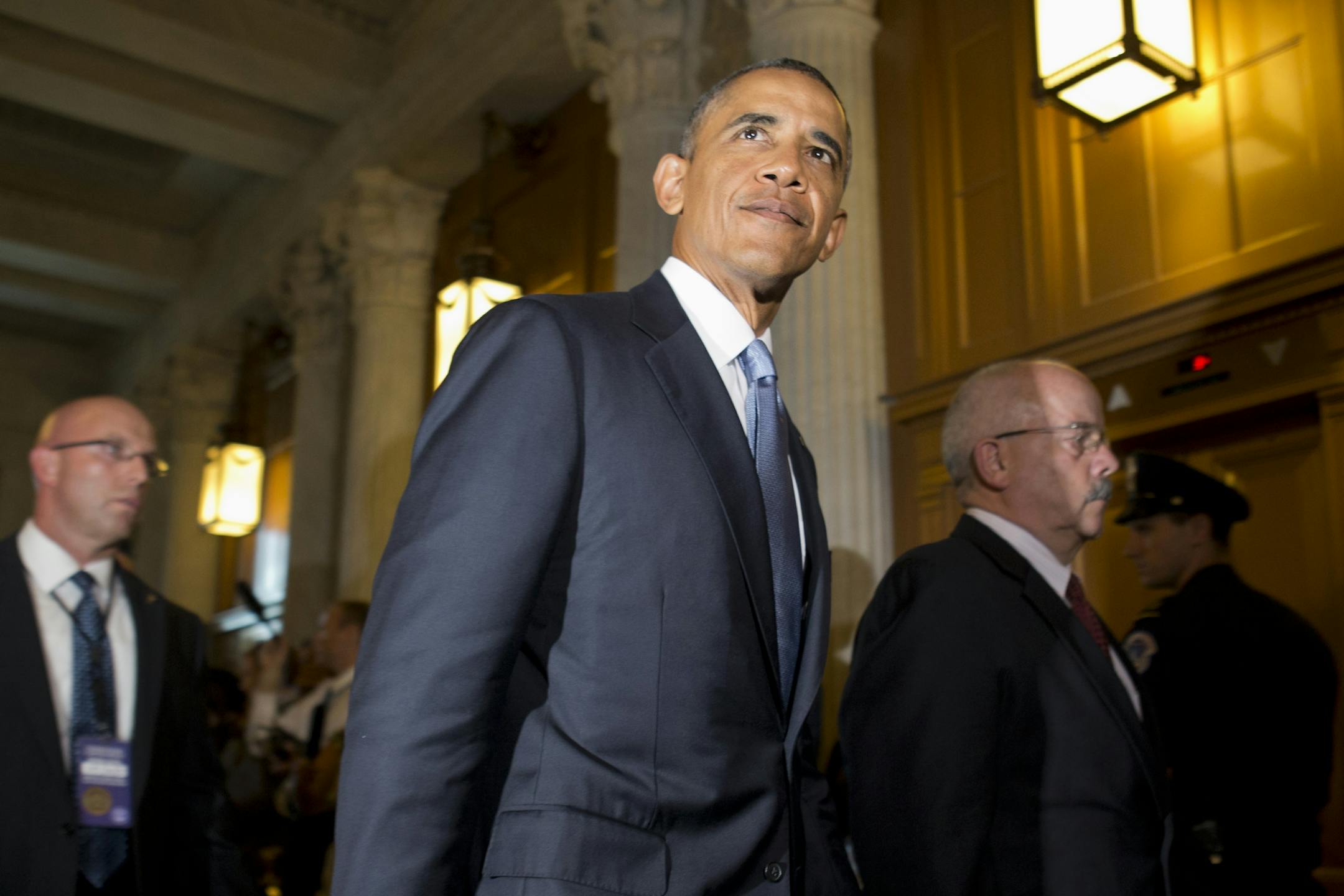 President Barack Obama, accompanied by Senate Sergeant at Arms and Doorkeeper Terrance Gainer, right, leaves a meeting with congressional Republicans on Capitol Hill in Washington, Tuesday, Sept. 10, 2013, where they discussed Syria. On Tuesday night, the president will address the nation on Syria.