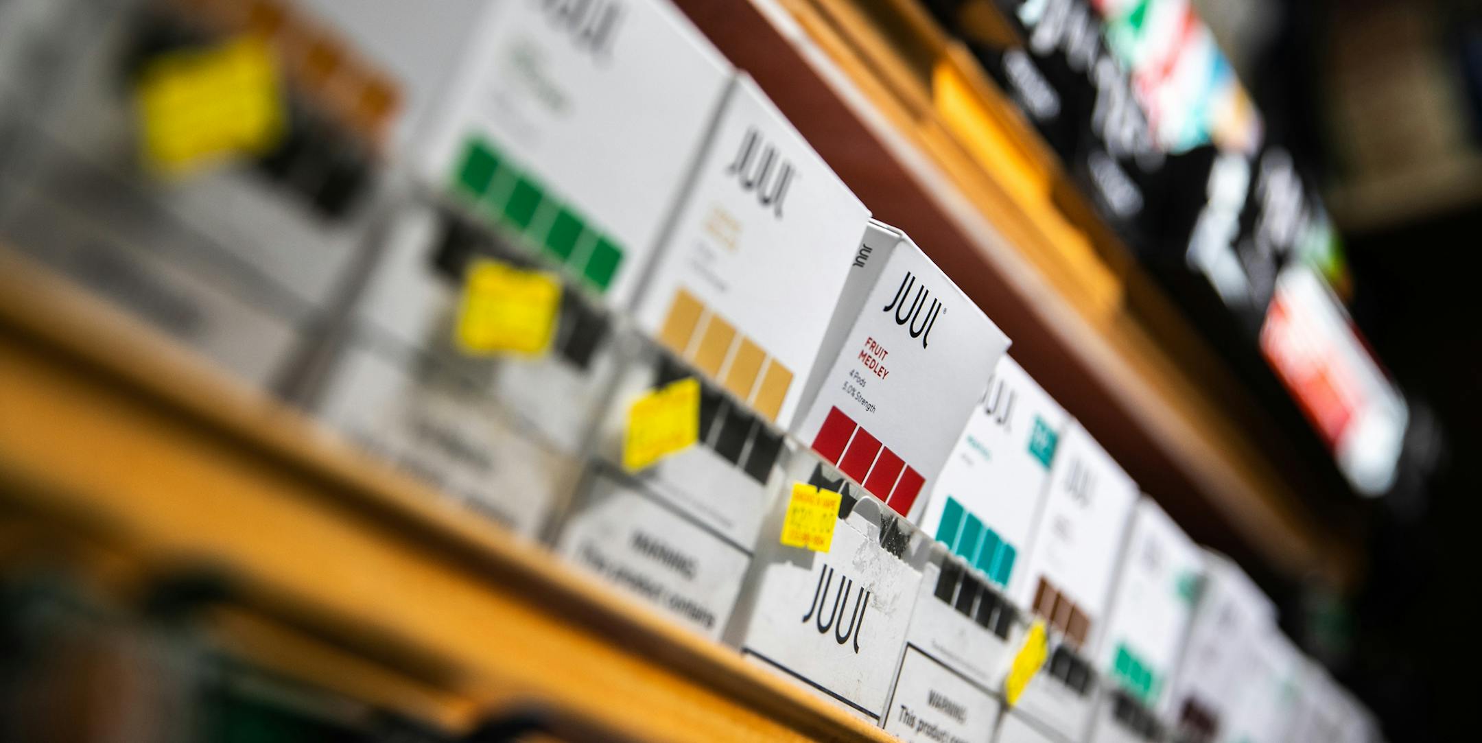 FILE -- Various flavors of Juul e-cigarettes on display at a store in Manhattan, Dec. 18, 2018. While meeting with top health officials on Wednesday, Sept. 11, 2019, President Donald Trump indicated that his administration was weighing restrictions on the sale of flavored e-cigarettes, at a time when hundreds of people have been sickened by mysterious vaping-related illnesses. (Jeenah Moon/The New York Times)