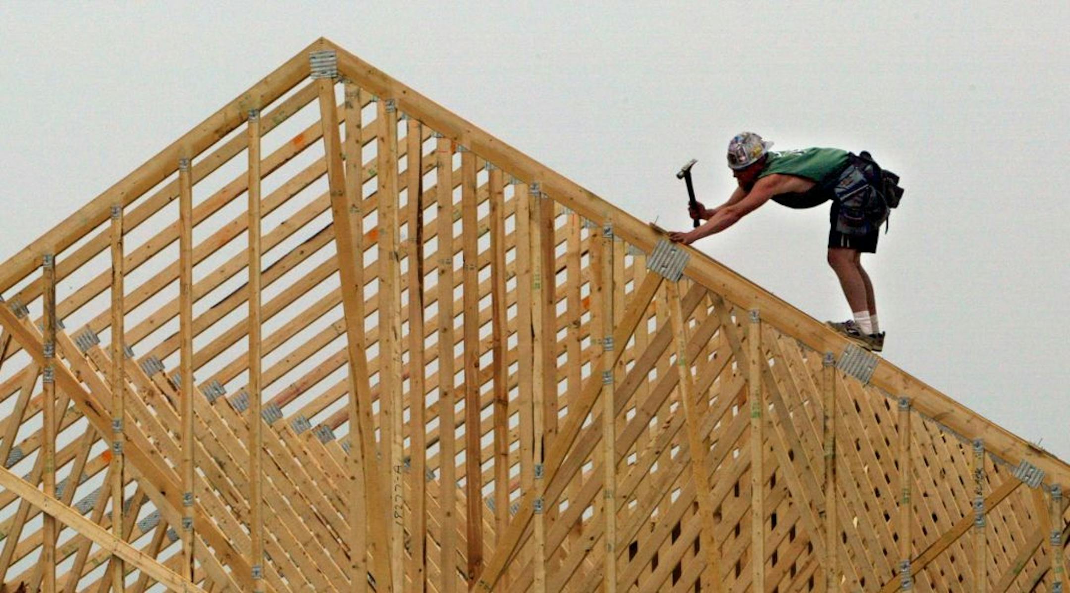 Zach Hunter frames a roof on a new home under construction in Lakeville. (he works for GENCO builders). GENERAL INFORMATION: Lakeville, MN 6/02/2003 The Dakota County city is one of several that found itself a last-minute target of budget negotiators at the State Capitol. Lakeville and other fast-growing, mostly Twin Cities suburban cities will not be able to use exemptions for growth in determining how much it can levy its taxpayers. That means that levying for things such as roads and sewers w