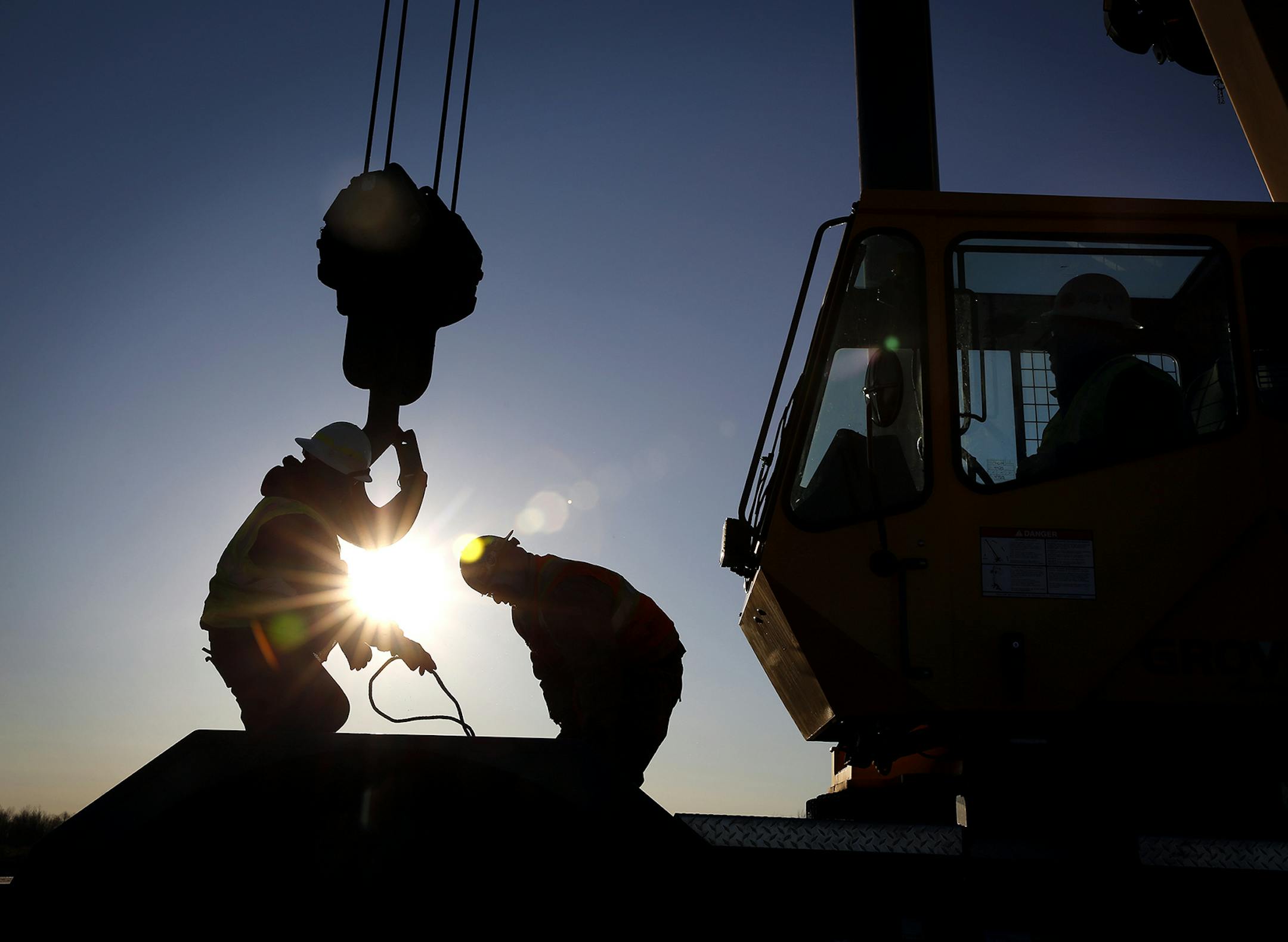Iron workers set up a crane to move steel for the construction of buildings on the site of Essar Steel Minnesota's taconite mine project in Nashwauk, Minn. ] LEILA NAVIDI leila.navidi@startribune.com / BACKGROUND INFORMATION: Friday, October 31, 2014. Essar Steel Minnesota recently ramped up construction on an $1.8 billion taconite plant after securing the funding needed to complete the project. The plant endured several delays over the past two years as funds periodically ran dry and some contr