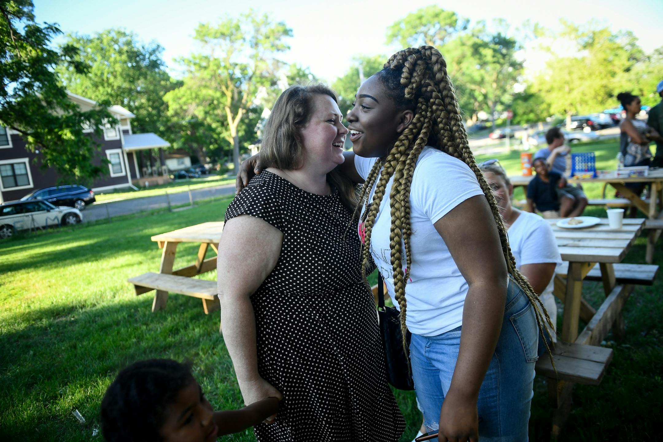 Emander Deward, right, hugged longtime friend from Redeemer Lutheran Church, Kristi Murray, as they ran into each other at Redeemer's community cookout Wednesday night.