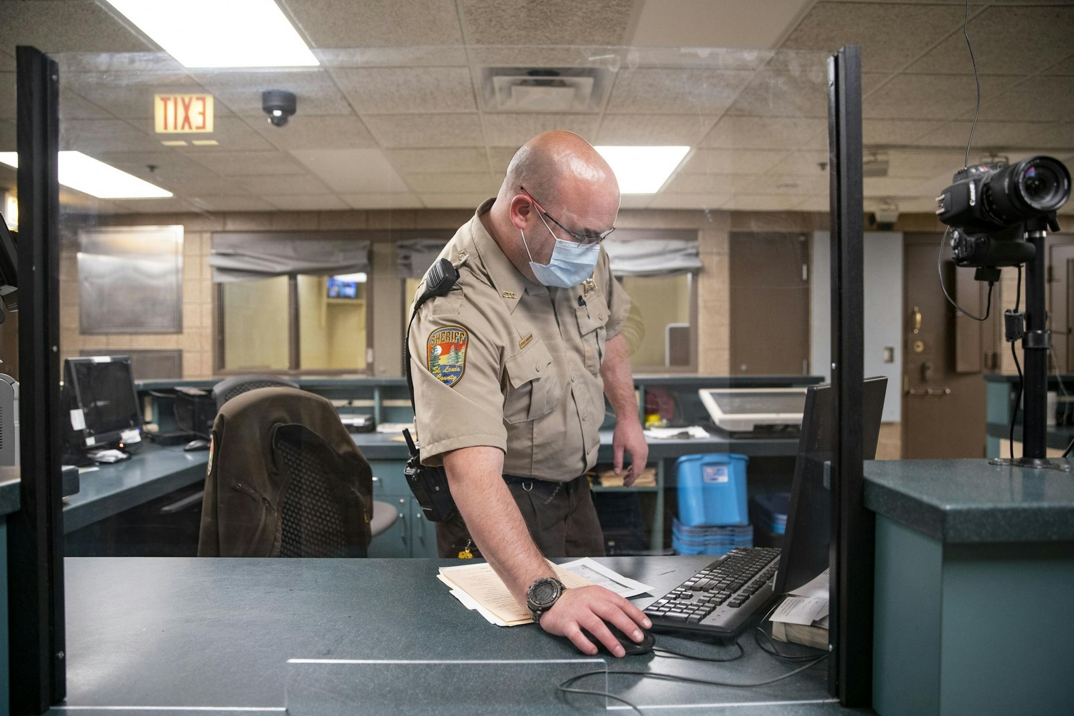 Corrections officer John Wohlwend donned a mask on Tuesday while working his shift at the St. Louis County jail.