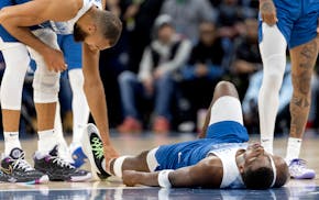 Wolves center Rudy Gobert checked on Anthony Edwards, who appeared to turn his ankle in the second quarter Tuesday at Target Center. Edwards returned