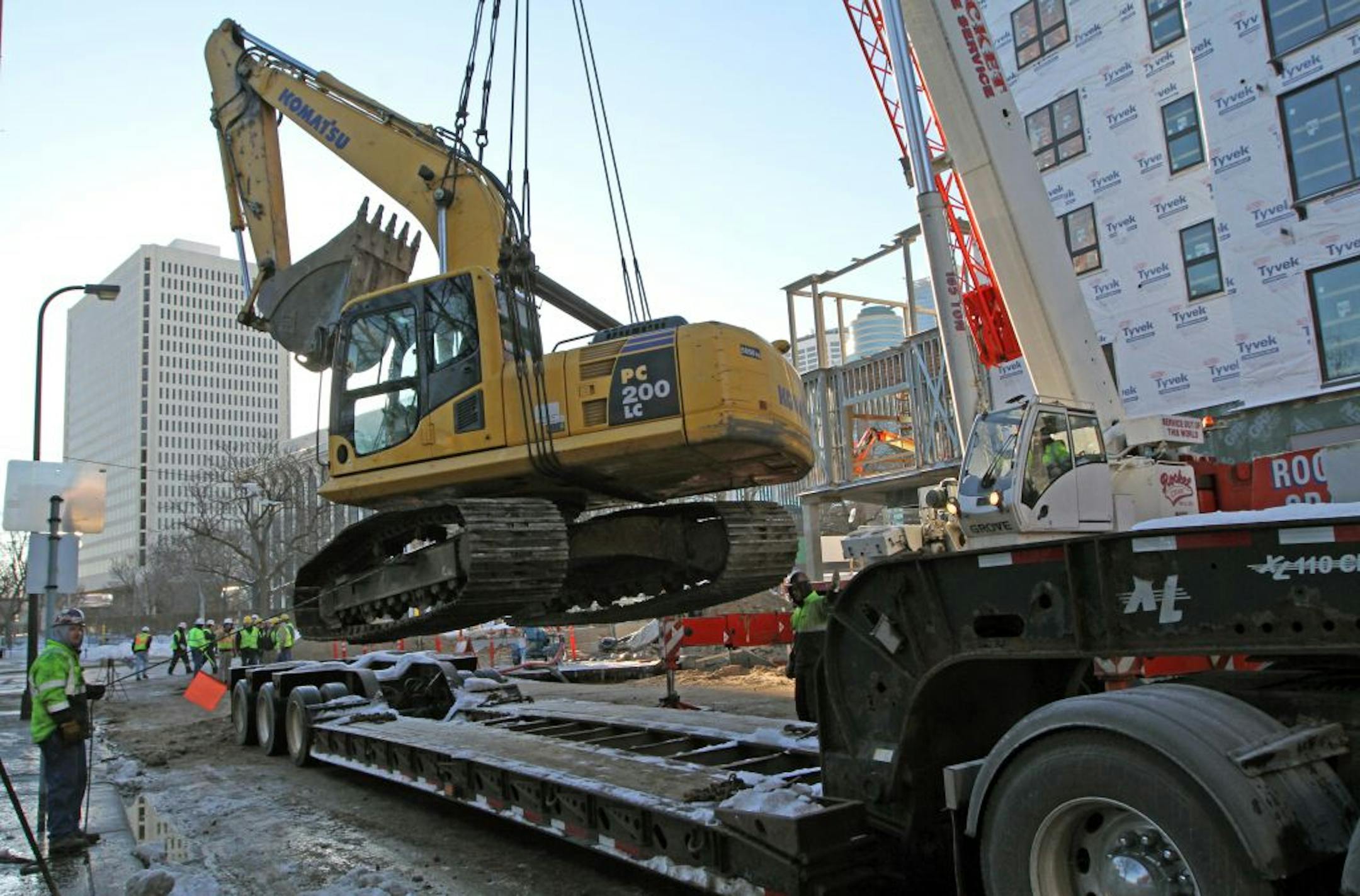 Jan. 4: Rocket Crane crews and utility workers used a crane to remove a backhoe out of the hole where the water main break occurred and onto a flatbed trainer along Hennepin Ave in downtown Minneapolis.