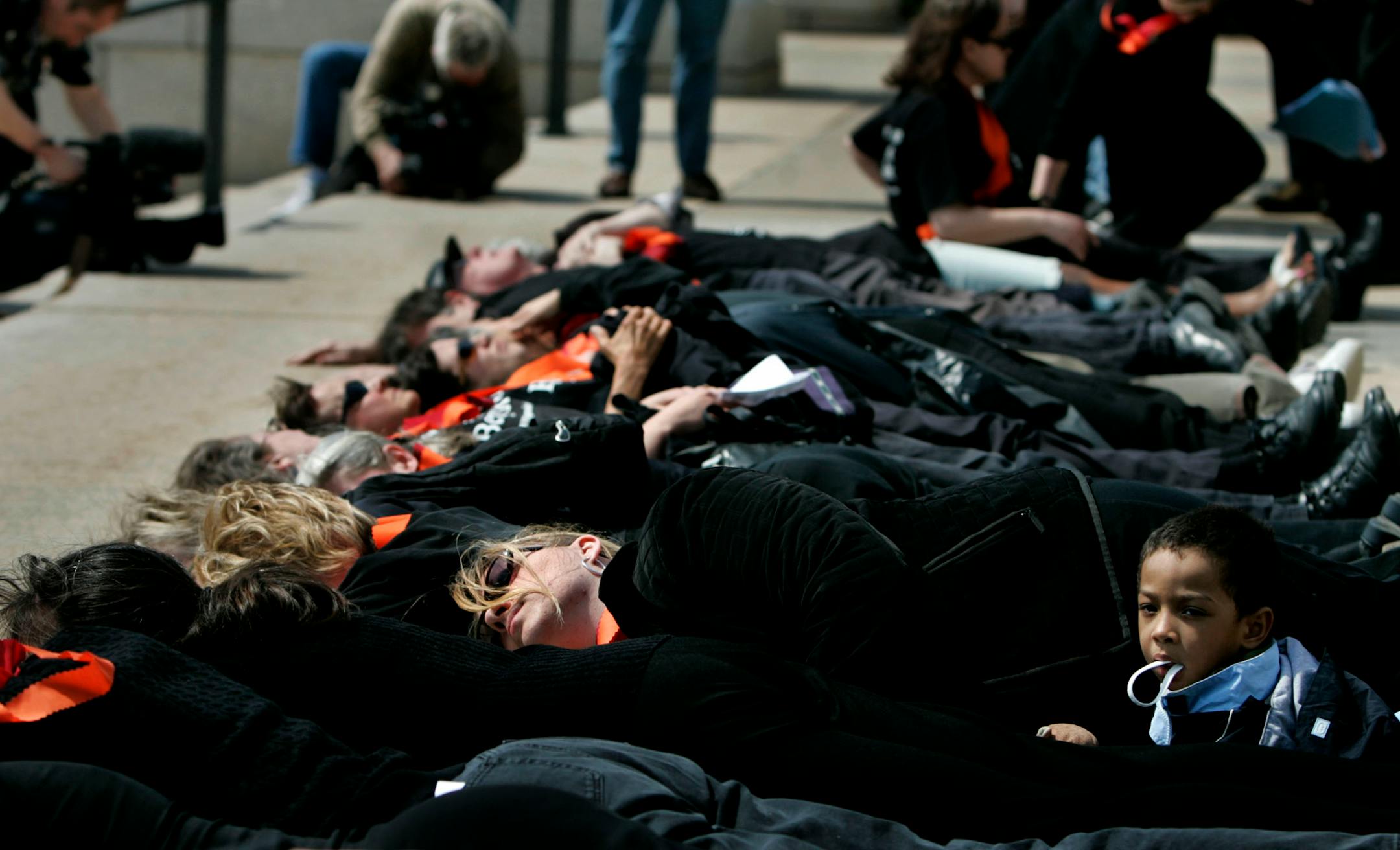 Susan Montgomery of Minneapolis, center, and her son Dyvonte, 3, were among the 32 participants in a "lie-in" outside the State Capitol to mark the year anniversary of the Virginia Tech shootings. Participants staged the event to "call attention to the fact that it is too easy for criminals and mentally ill individuals to obtain guns in Minnesota," according to a statement by Protect Minnesota.