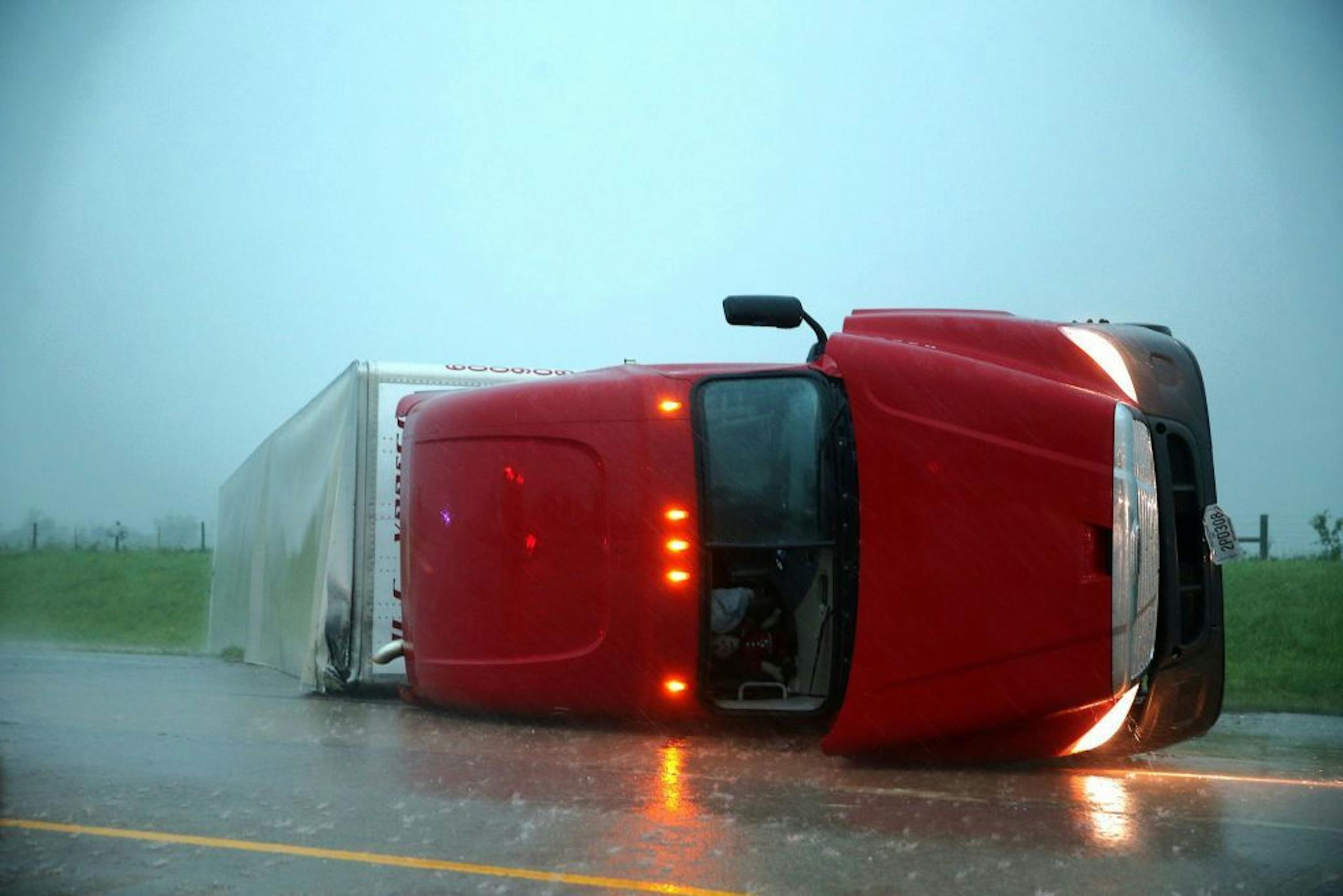 An overturned semitrailer rests on its side on the eastbound lanes of Interstate 40, just east of El Reno, Okla., after a reported tornado touched down, Friday, May 31, 2013. (AP Photo/The Omaha World-Herald, Chris Machian) MANDATORY CREDIT