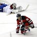 New Jersey Devils' Zach Parise (9) celebrates his goal as Montreal Canadiens goalkeeper Carey Price lays on the ice during the third period of an NHL 