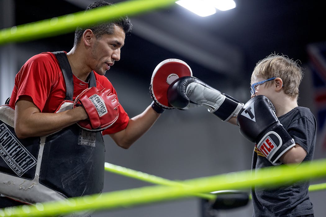 Boxing coach Jorge Mendoza sparred with student Oliver Olthoff.