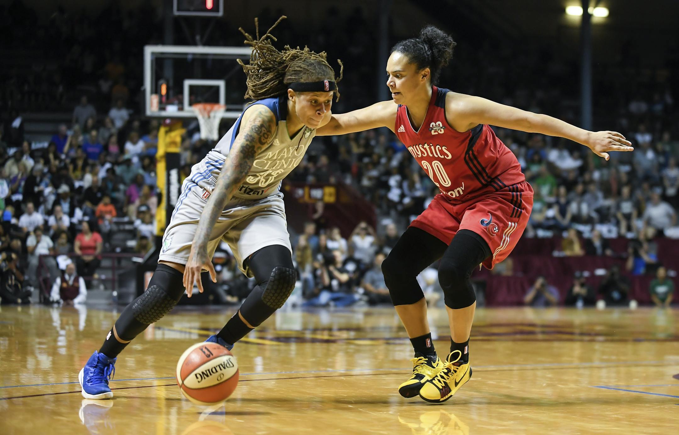Minnesota Lynx guard Seimone Augustus (33) moves the ball toward the basket while being defended by Washington Mystics guard Kristi Toliver (20) during the second half of a WNBA basketball game, Tuesday, Sept. 12, 2017 in Minneapolis. (Aaron Lavinsky/Star Tribune via AP)