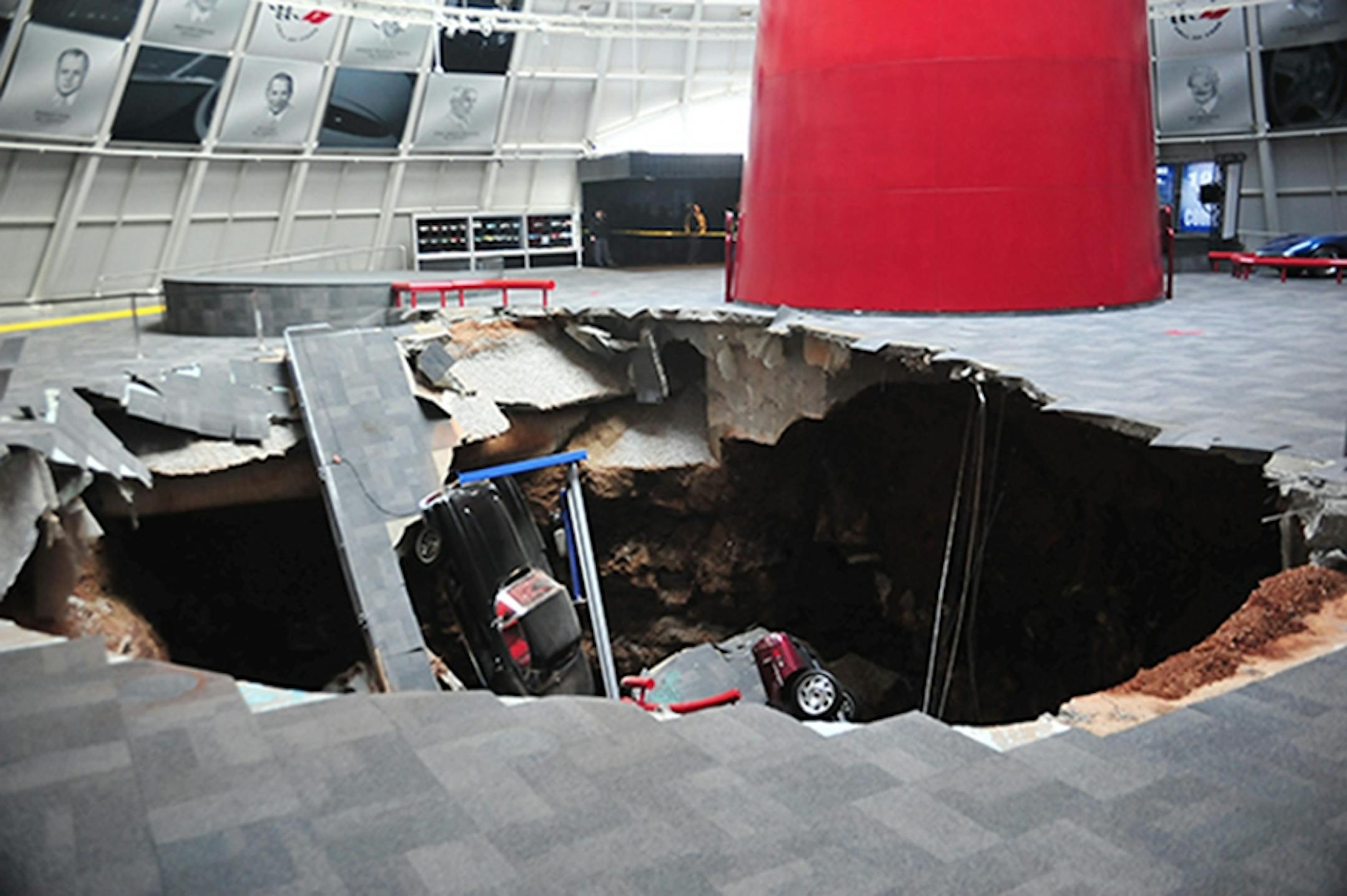 In this image provided by the National Corvette Museum shows several cars that collapsed into a sinkhole Wednesday, Feb. 12, 2014, in Bowling Green, Ky.