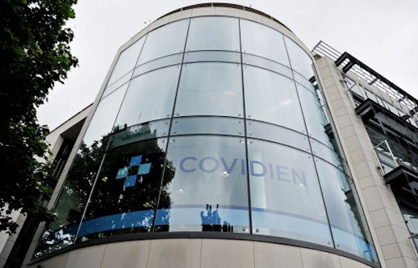 A Covidien logo sits on the glass windows of medical device manufacturer Covidien Plc's head office in Dublin, Ireland, on Monday, June 16, 2014. Medt