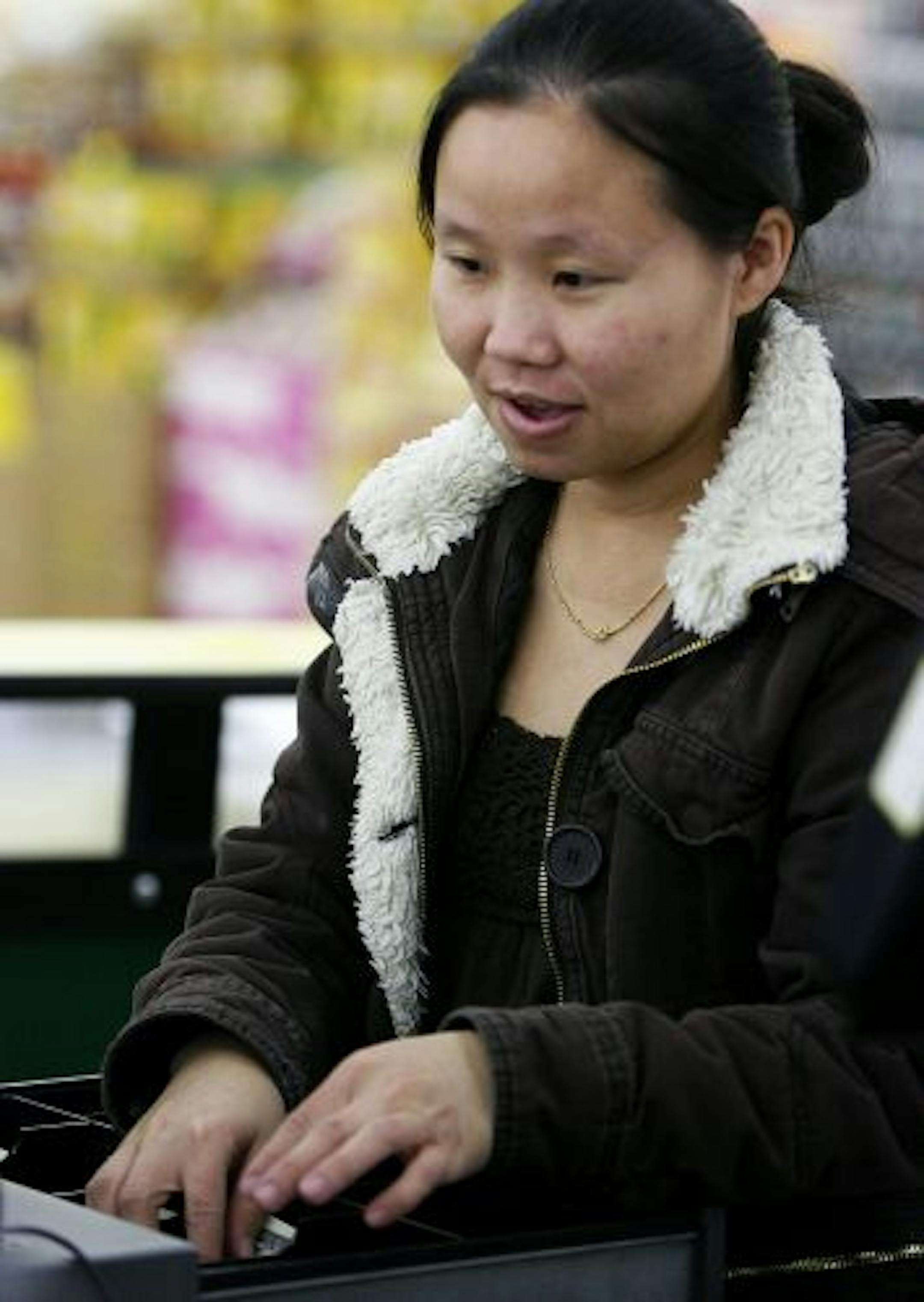 Ia Thao, a cashier at a grocery store on University Avenue in St. Paul, said the increase in food stamp benefits will help her family of five.