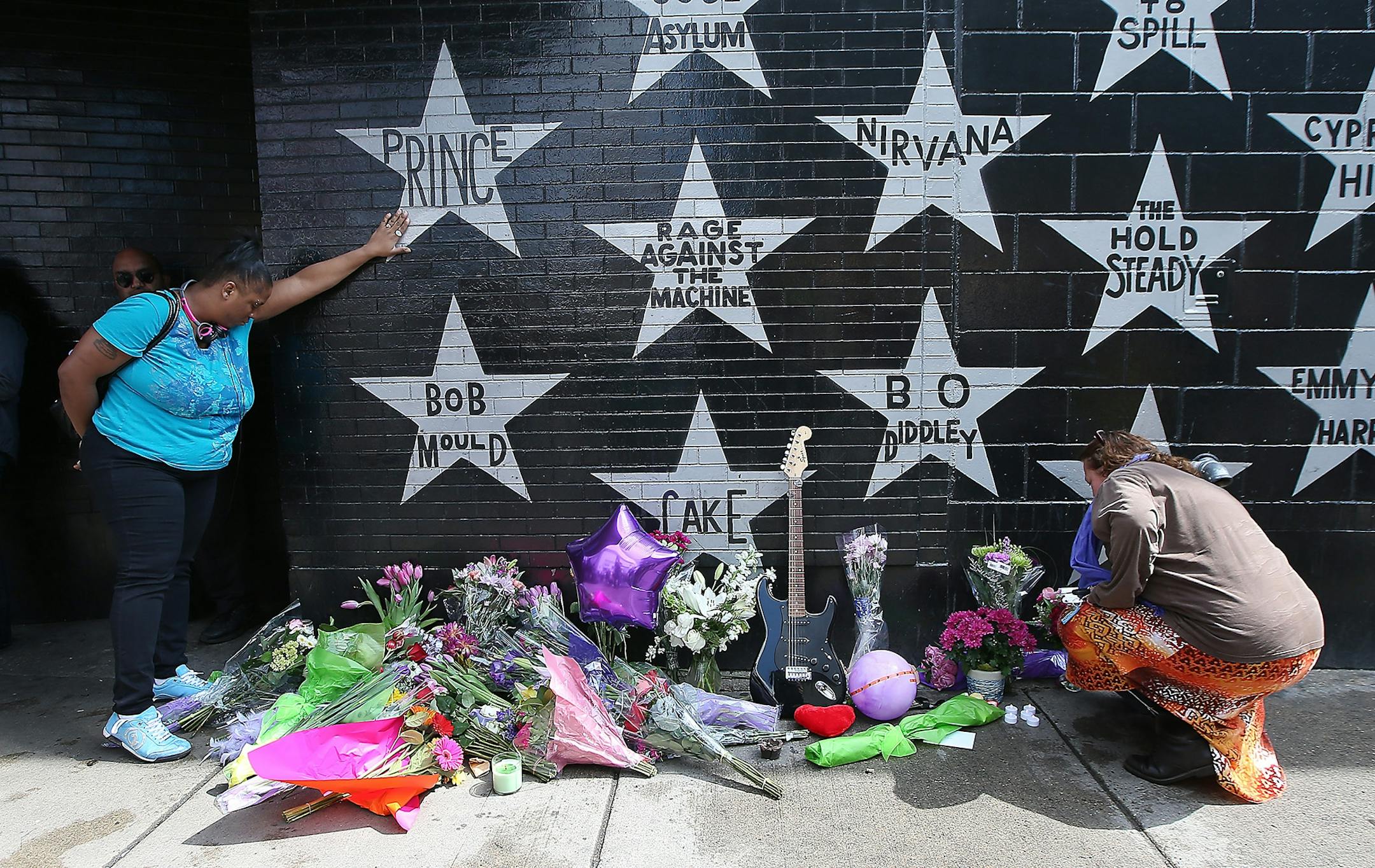 Many fans made their way to leave flowers beneath Prince's star at First Avenue after news of his death was made, Thursday, April 21, 2016 in Minneapolis, MN.