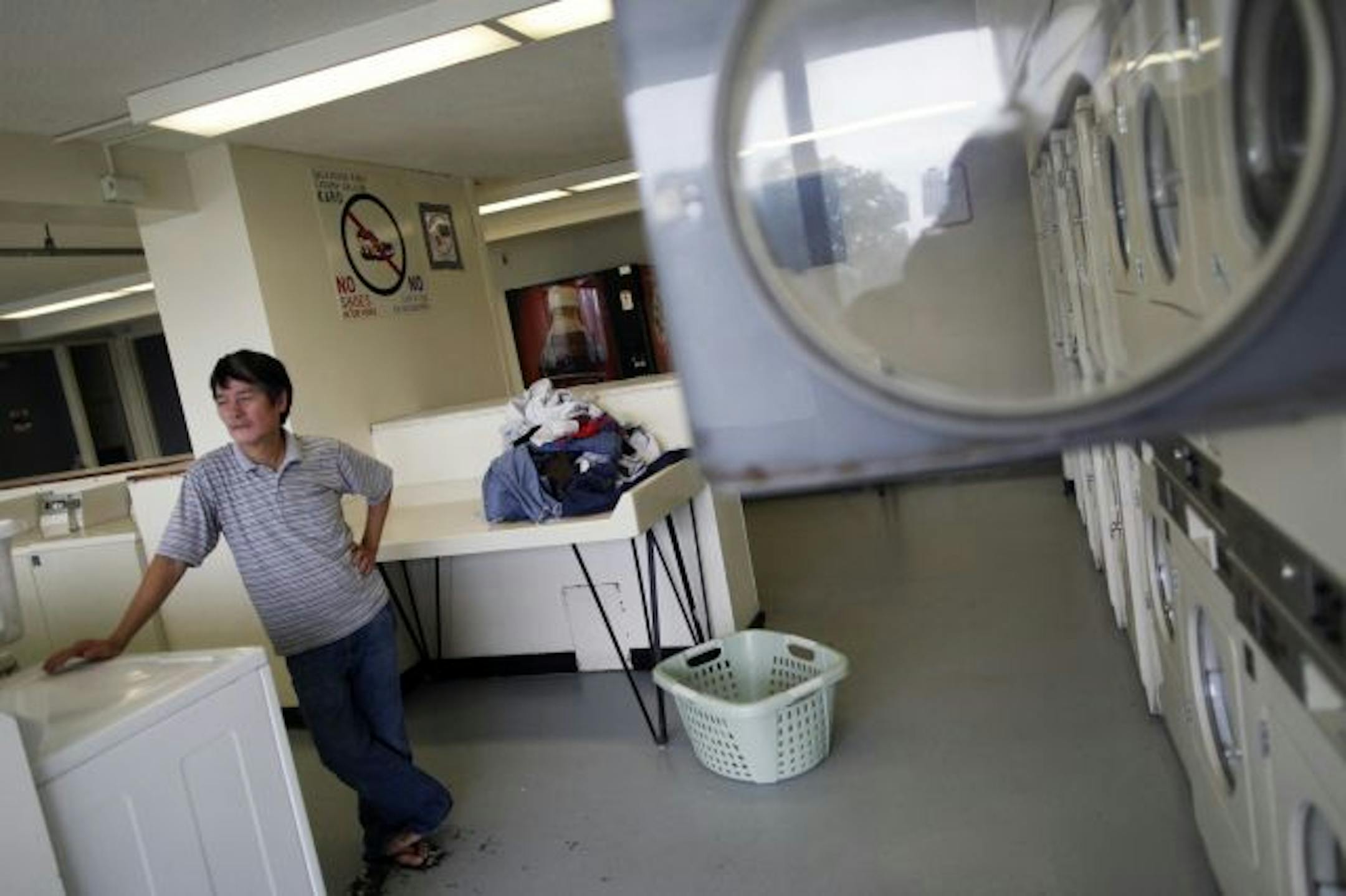 Tap To, who has lived at Riverside Plaza for 20 years, says the coin-operated laundry machines in his building can be unreliable. Under the plan, the complex's heating, cooling and other systems will be fixed.