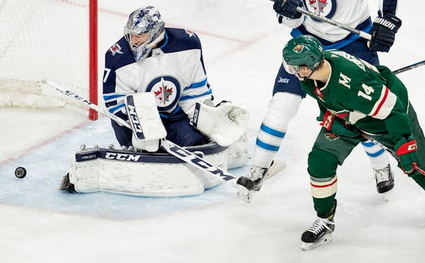 Matt Dumba (not in frame) got the puck past Connor Hellebuyck (37) for a goal in the second period on Sunday.