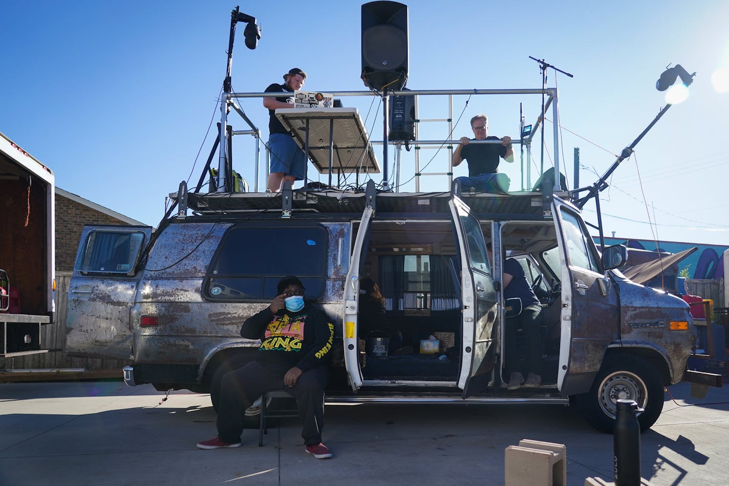 DJ Hayes (left) and Stuart DeVann were on the roof as Nur-D sat on the ground before their Bands on Vans soundcheck.