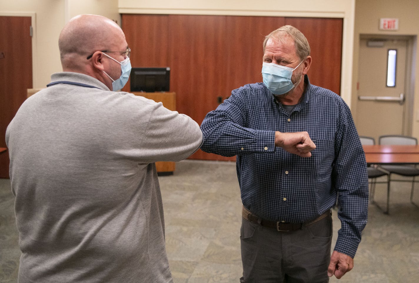 (Left) Tim White and Bob Schlicht exchanged an elbow bump to start their meeting at Essentia Health-St. Mary's Medical Center in Duluth on Friday October 16, 2020. The two men are the only people in the world to have received the experimental treatment that saved both their lives. ] ALEX KORMANN • alex.kormann@startribune.com After contracting COVID-19 in the spring, two Minnesota patients in Duluth were on the brink of death from ARDS, a type of respiratory failure. They became the first people