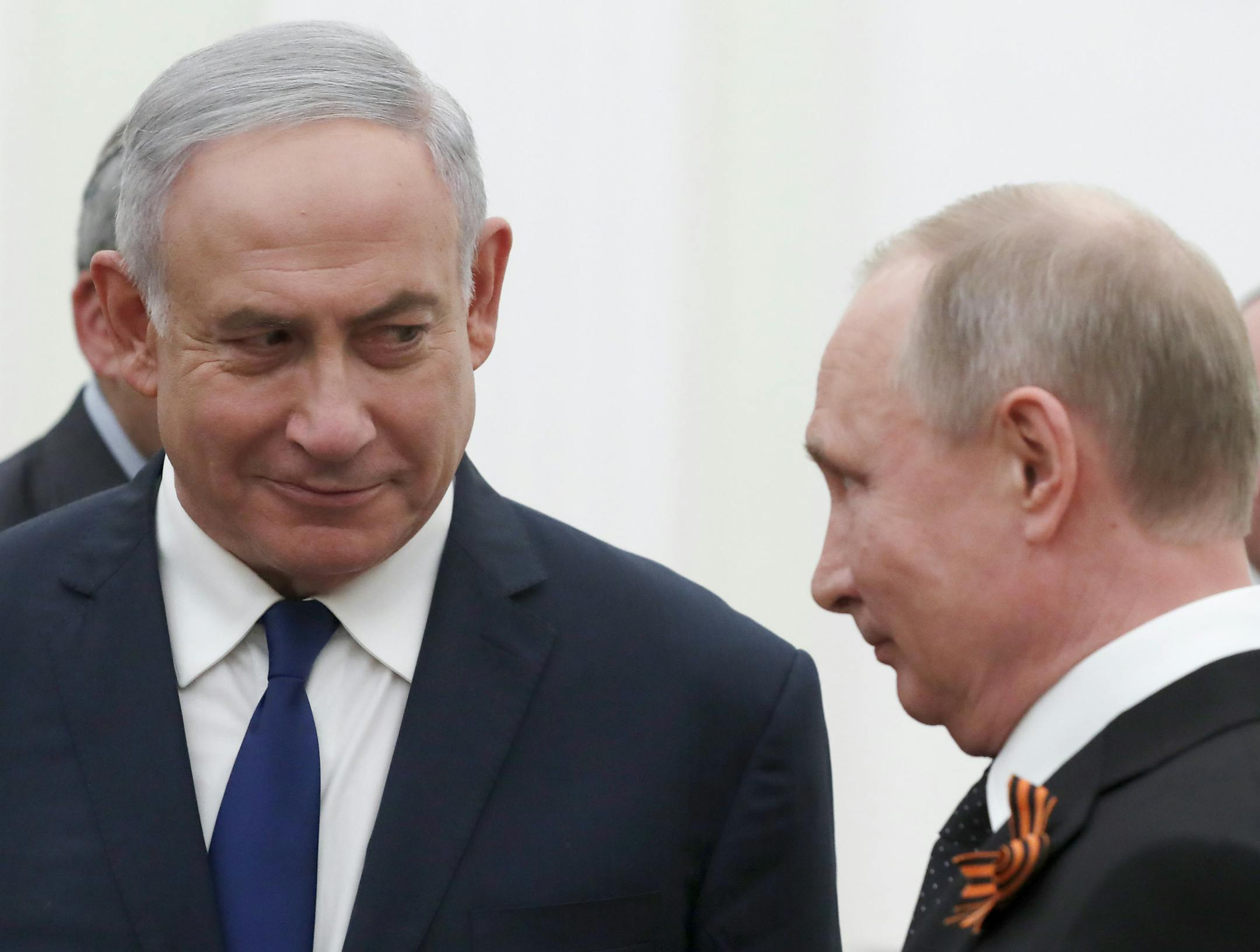 Russian President Vladimir Putin, right, and Israeli Prime Minister Benjamin Netanyahu talk to each other during their meeting in the Kremlin in Moscow, Russia, Wednesday, May 9, 2018. (Sergei Ilnitsky/Pool Photo via AP)