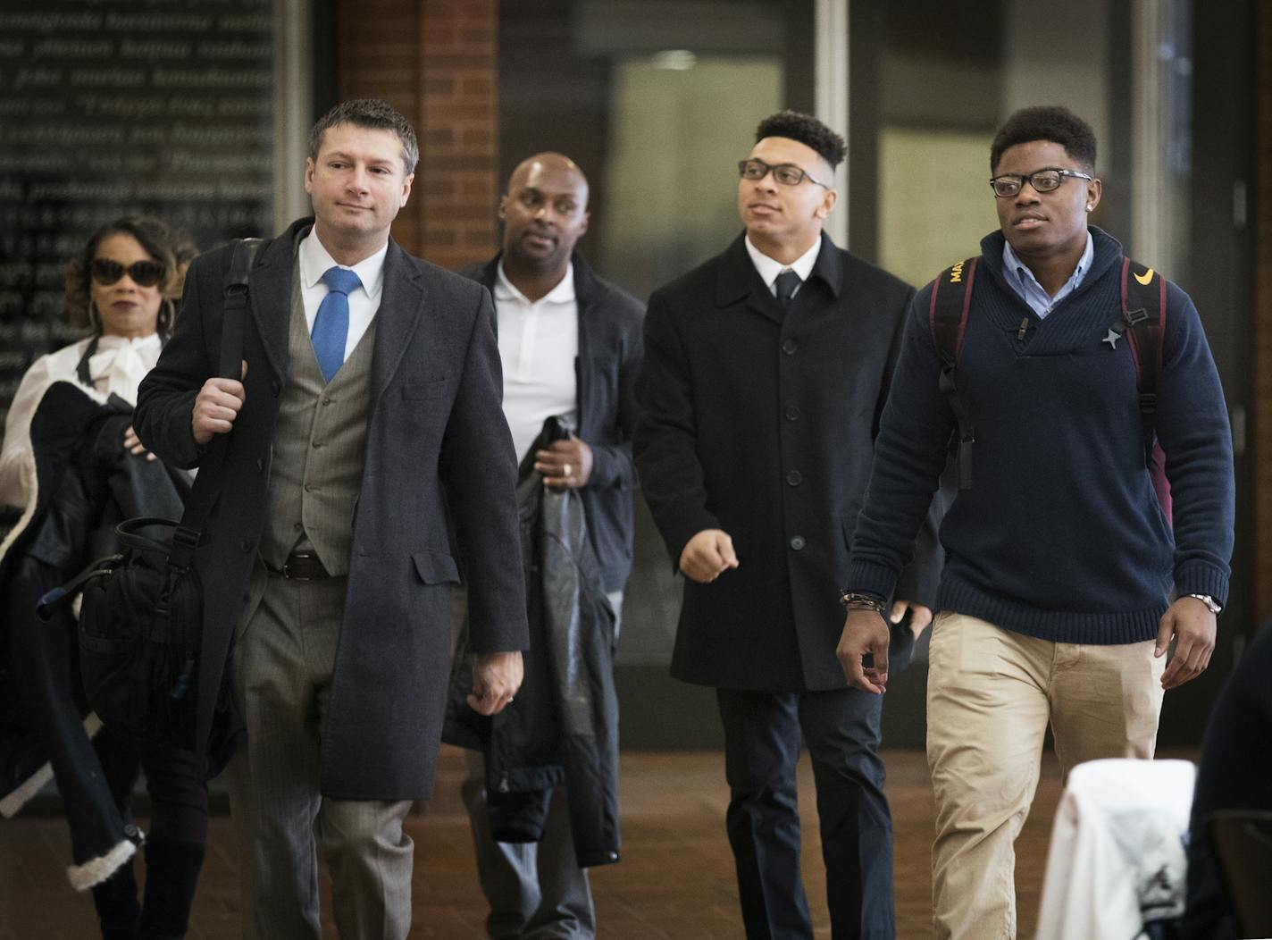 Lawyer Ryan Pacyga, left, walks with Minnesota football players Carlton Djam, from right, and Antoine Winfield, Jr, accompanied by his father, former Vikings player Antoine Winfield, Sr. into their appeal hearing. ] (Leila Navidi/Star Tribune) leila.navidi@startribune.com BACKGROUND INFORMATION: Ten suspended University of Minnesota football players arrive at the Humphrey School of Public Affairs on the campus of University of Minnesota in Minneapolis on Thursday, January 26, 2017 for the appeal