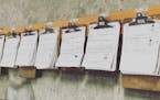 Clipboards with paper inspection sheets hang on the wall of a Washington State Department of Transportation maintenance office in Moses Lake in 2014. 