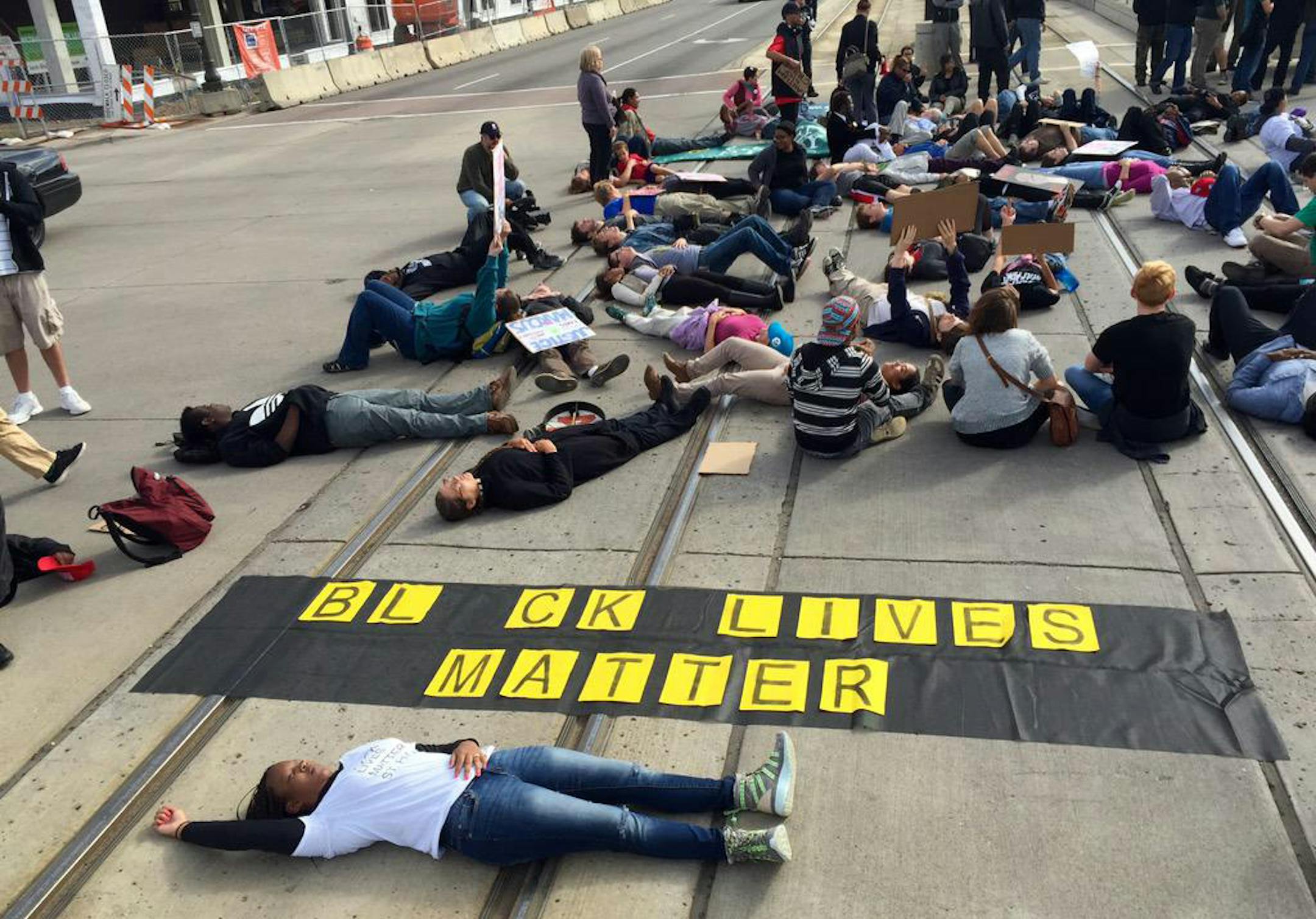 Protesters stage a die-in on the light rail tracks on Sunday morning. Meanwhile, Metro Transit says buses are replacing Green Line traffic in the area.