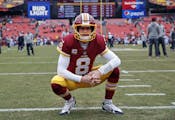 FILE - In this Dec. 24, 2017, file photo, Washington Redskins quarterback Kirk Cousins looks around the stadium before an NFL football game against th
