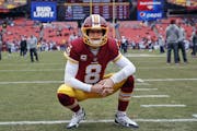 FILE - In this Dec. 24, 2017, file photo, Washington Redskins quarterback Kirk Cousins looks around the stadium before an NFL football game against th
