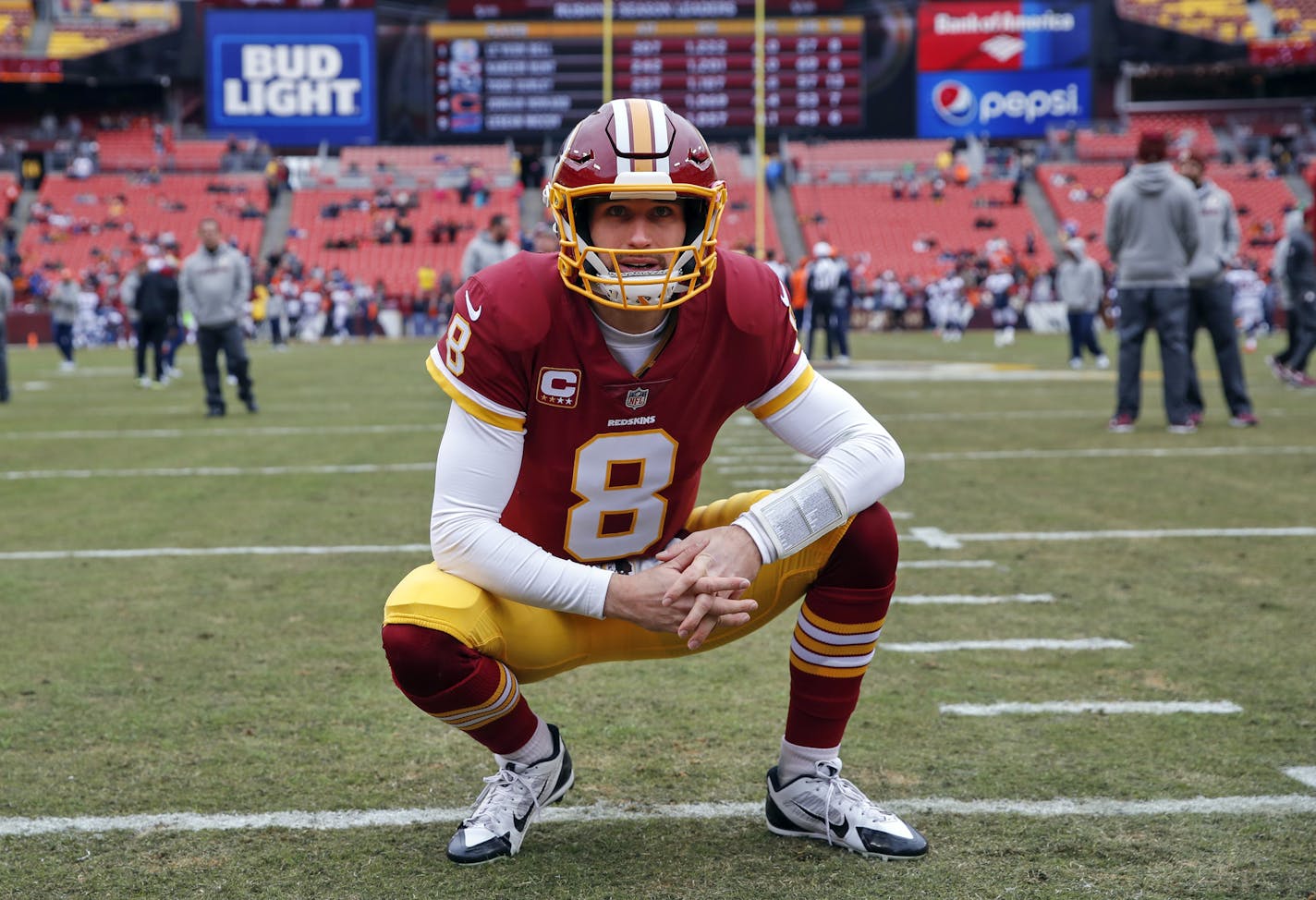 FILE - In this Dec. 24, 2017, file photo, Washington Redskins quarterback Kirk Cousins looks around the stadium before an NFL football game against the Denver Broncos in Landover, Md. After agreeing to a trade to acquire quarterback Alex Smith, the Redskins are moving on from the Kirk Cousins era. When the league year opens in mid-March, Cousins will be the top free agent available and find no shortage of suitors for his services. (AP Photo/Alex Brandon, File)