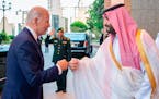 In this image released by the Saudi Royal Palace, Saudi Crown Prince Mohammed bin Salman, right, greets President Joe Biden with a fist bump after his